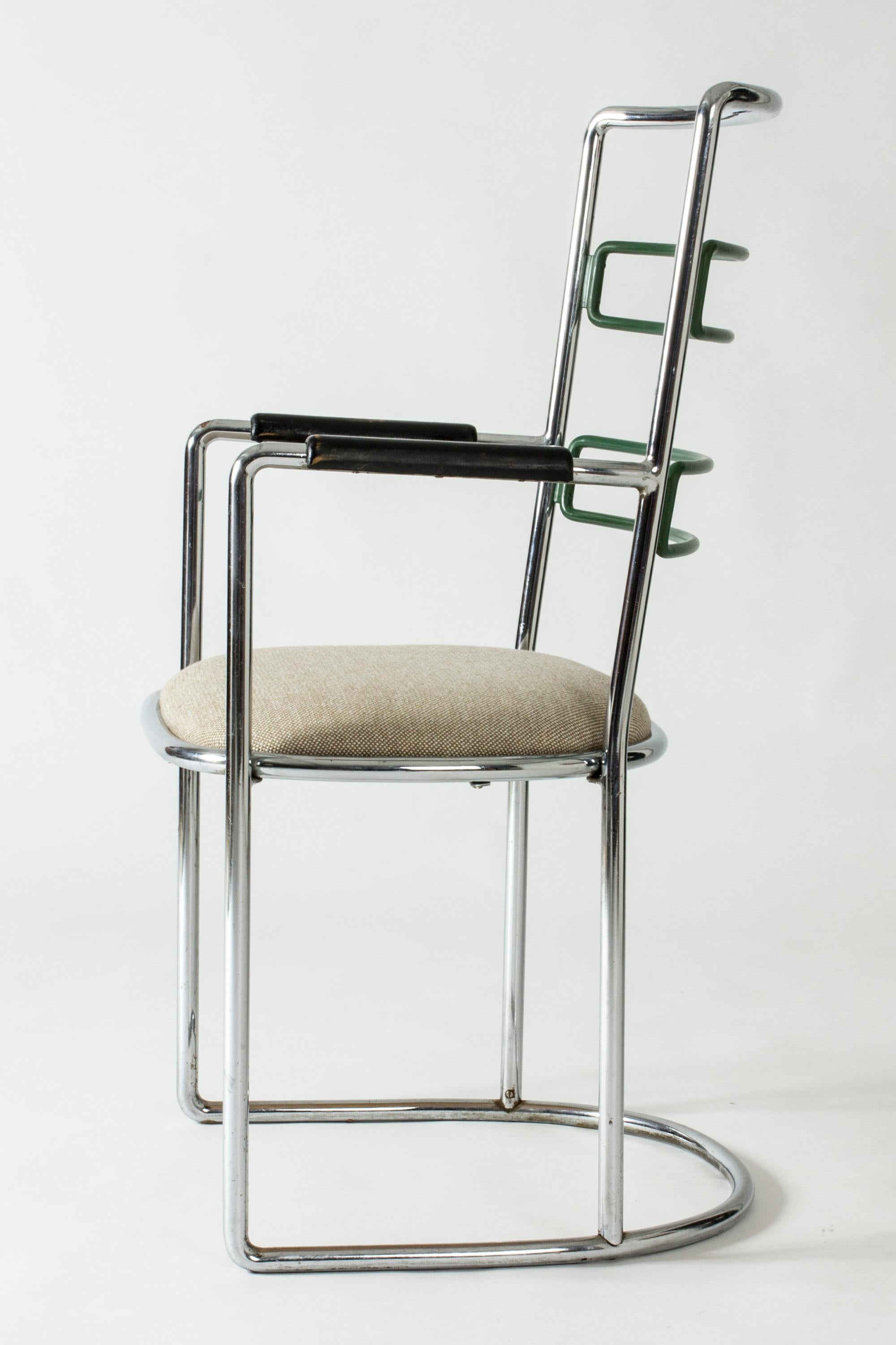 Striking lounge chair by Axel Einar Hjorth, designed in 1930. Strict, sleek form made in steel, with upholstered seat, wooden armrests and green lacquered back detail.

Literature: Christian Björk, Thomas Ekström and Eric Ericson, Axel Einar