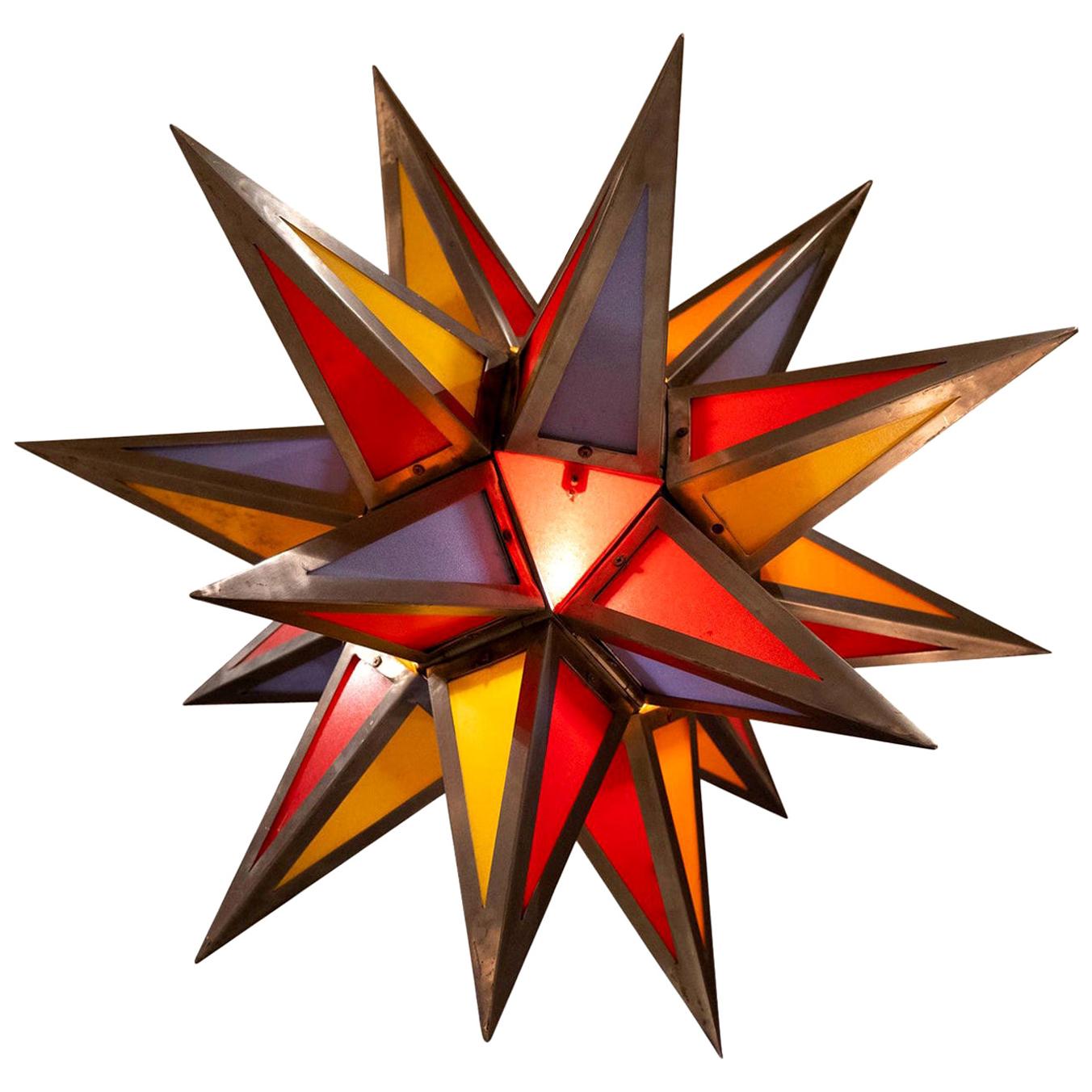 A large colorful midcentury steel and Bakelite star pendant.