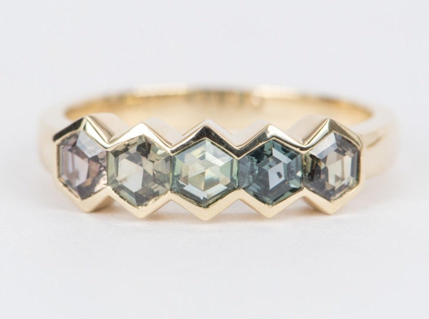 ♥ Solid 14k yellow gold ring set with beautiful hexagon-shaped Montana sapphires in a bezel setting
♥ Gorgeous blue green color!
♥ The item measures 5.5 mm in length, 17.5 mm in width, and stands 3.8 mm from the finger, band width 2.7mm

♥ Gemstone: