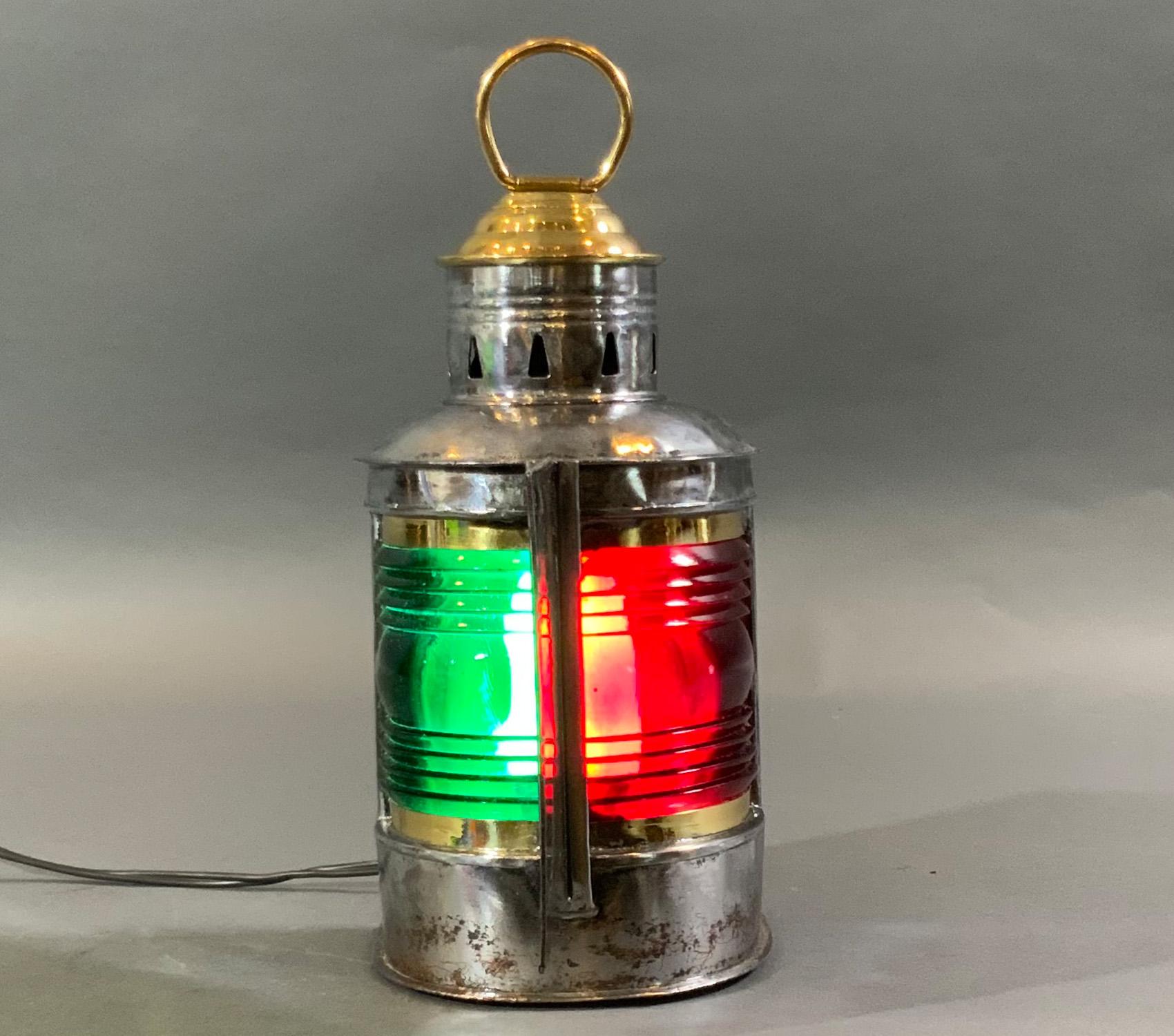 Polished steel bow lantern from a boat. Fitted with red and green Fresnel lenses. Brass cap with hoisting ring. Some staining on metal. With Wilcox Crittenden label fitted with socket and wired for home use.

Weight: 3 LBS
Overall dimensions: 10”