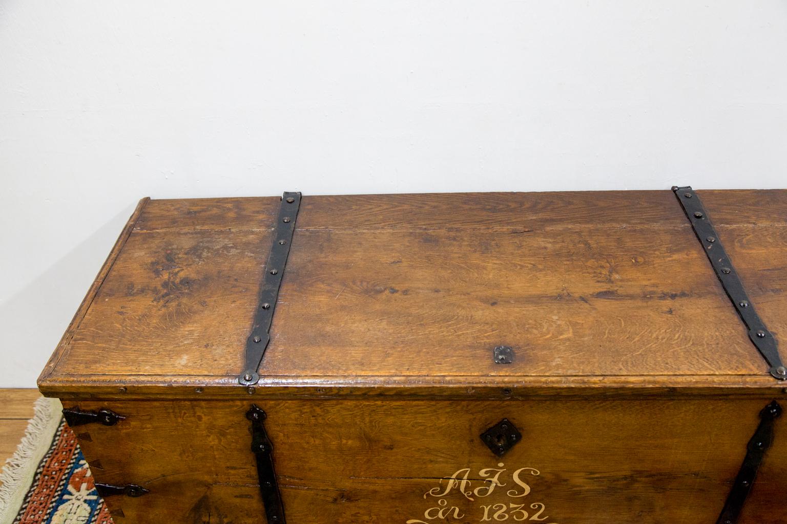 Steel bound oak blanket chest is dated 1832. It has the original heavy steel strap hinges and steel lock. (Not in working condition). There is an interior candle box.