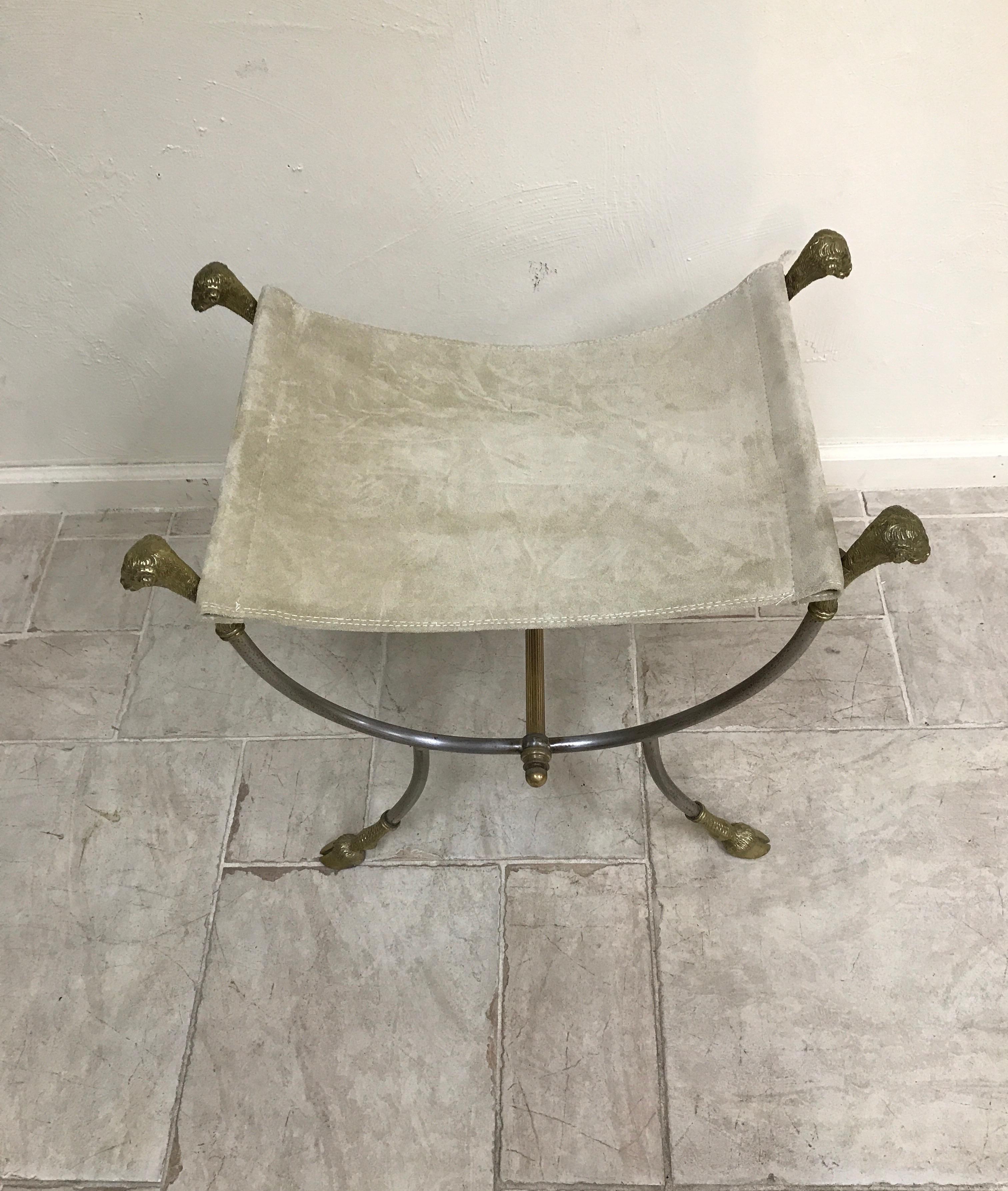 Neoclassical steel and brass ram's head stool with hoof feet. Genuine suede sling seat.