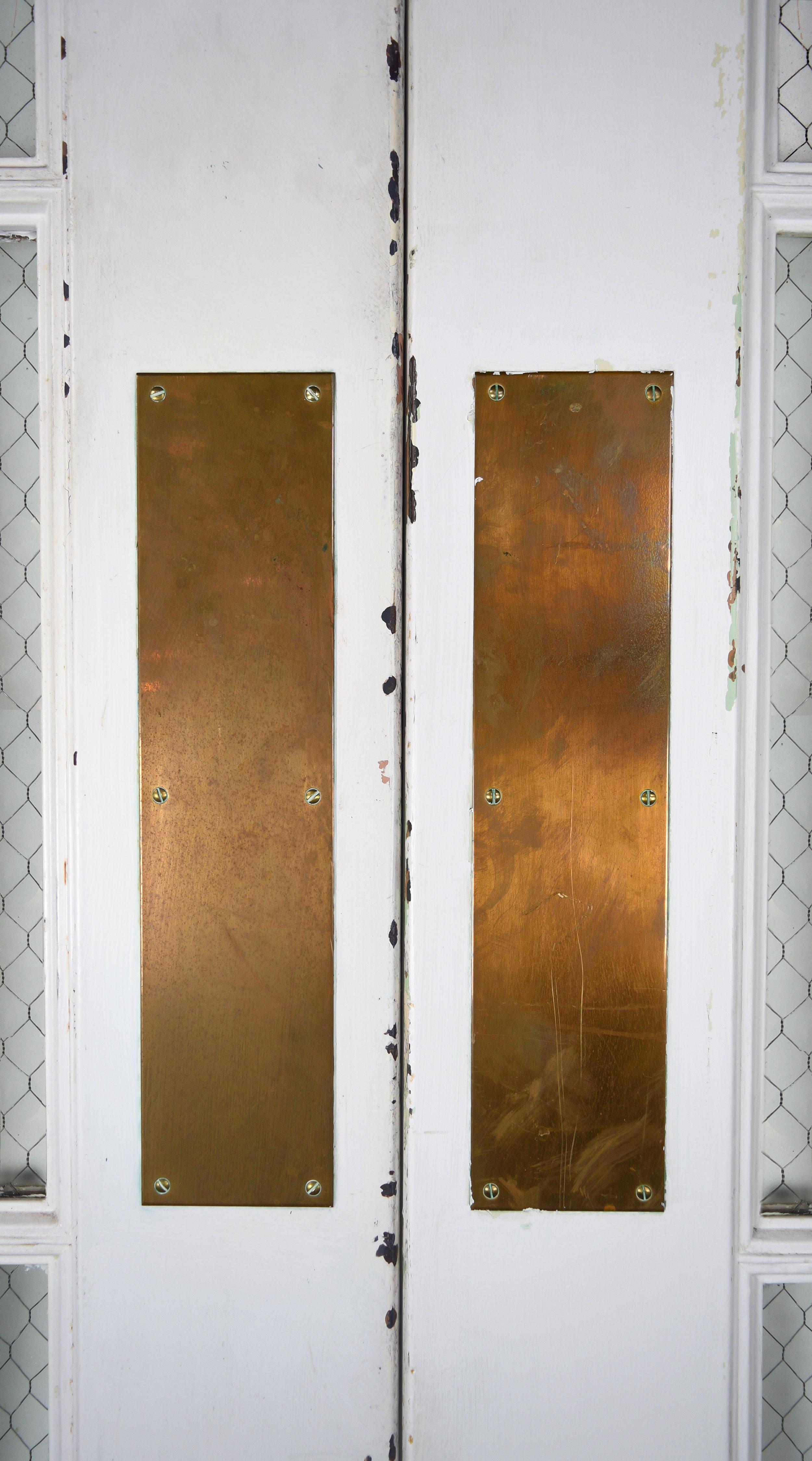 These sturdy steel double doors are well-built and feature double hinges. Their most unique feature is the chicken wire that sits within the glass adding extra strength and security. 

2 sets available 
Circa: 1920’s
Condition: Good
Finish: