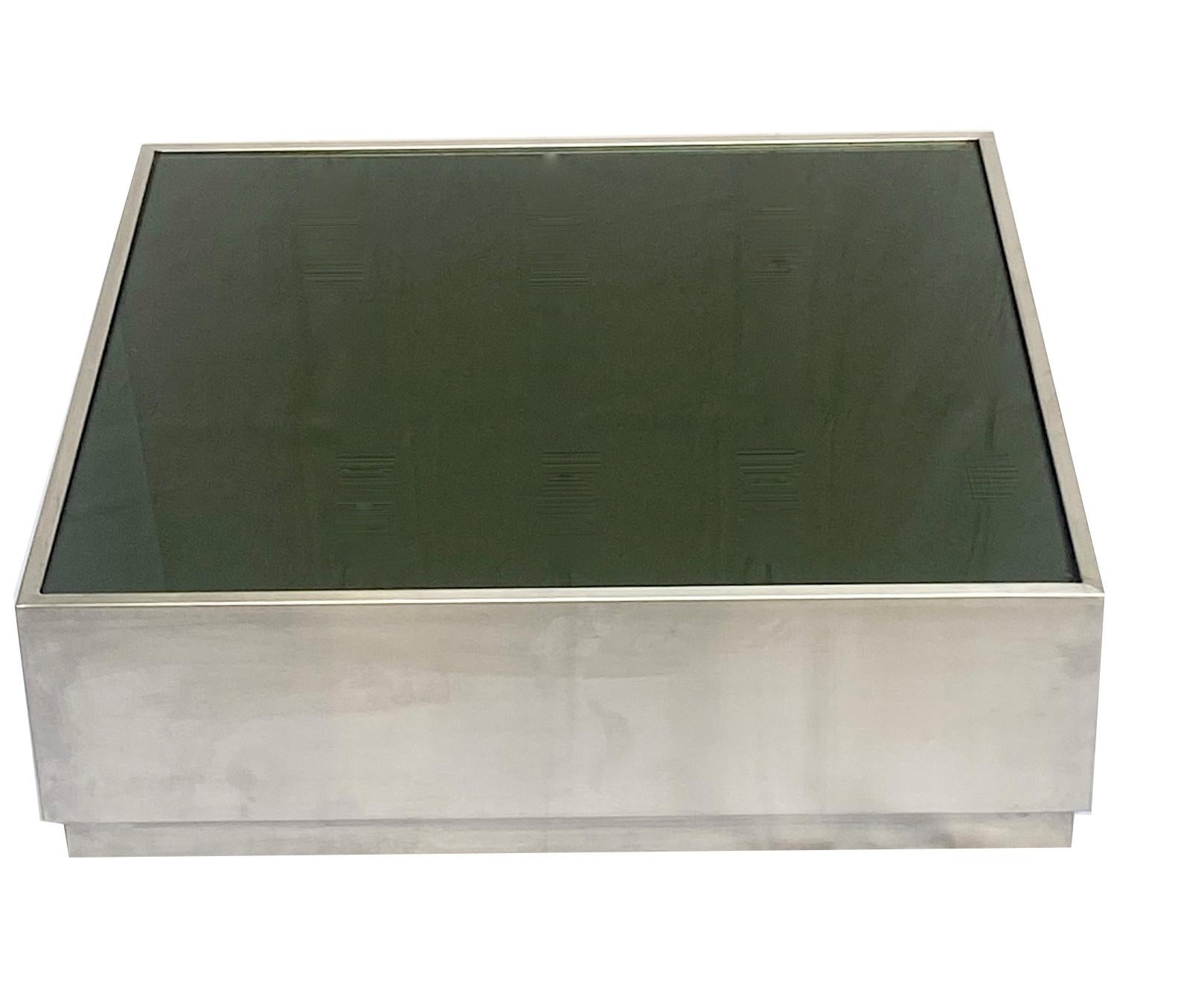 Amazing brushed stainless steel coffee table with smoked green glass top. This wonderful piece was designed in the 1970s.