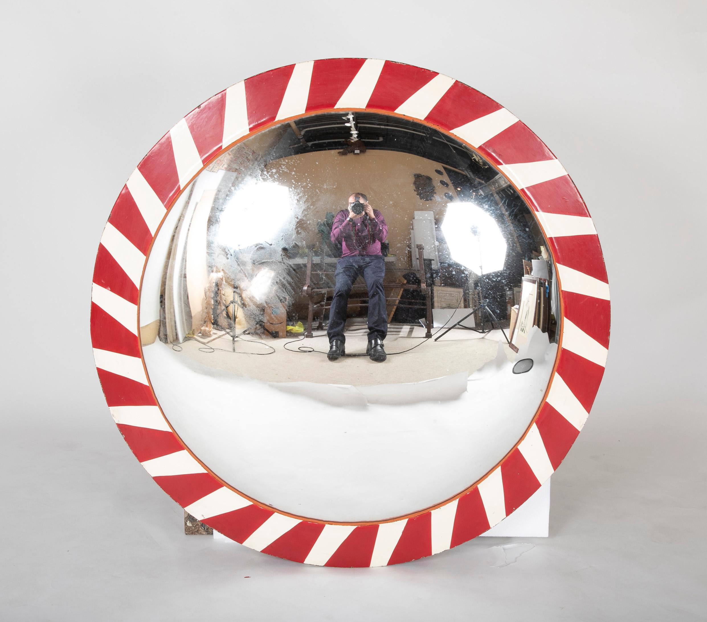 Unusual and very cool convex mirror in a steel frame painted with red and white stripes, said to come from a railroad in Belgium. The grand scale and novel coloring make this a singular decorative element.
Measures: 45 inches diameter, 4 inches