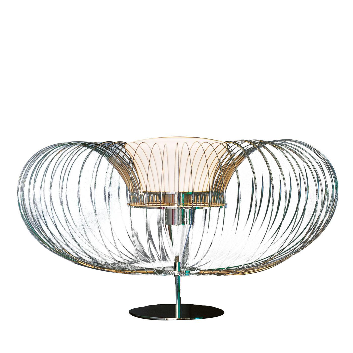 The unique steel flower T table lamp is the perfect accessory to add a touch of sophistication in your home or office. The structure and base are crafted in chromium-plated brass, while the top features harmonic steel wires and the Illuminating unit