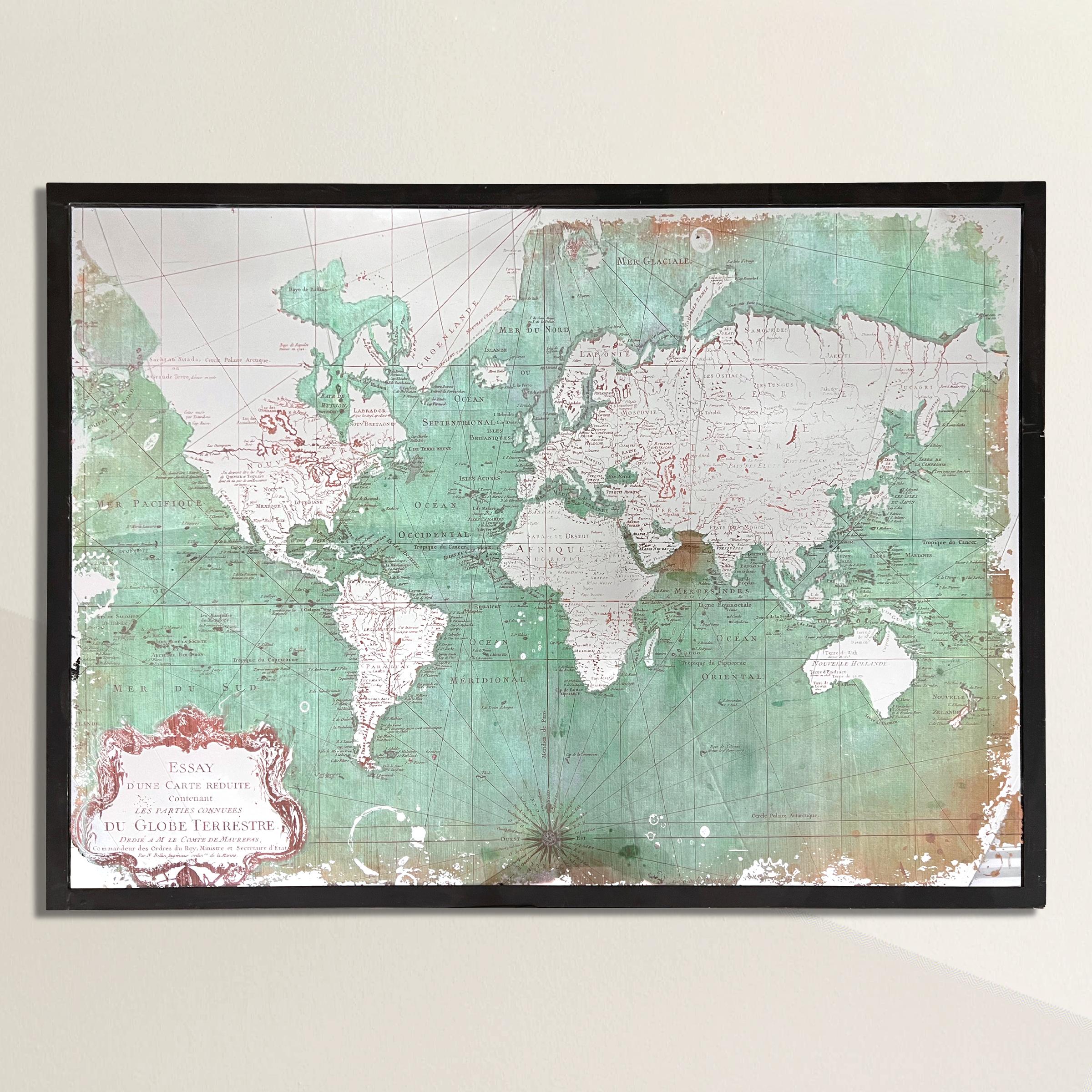 A 21st century American steel-framed world map mirror—an exquisite fusion of functionality and artistry that adds a touch of wanderlust to any space. This meticulously crafted mirror features an 18th century French world map with mirrored