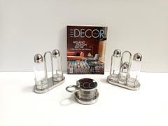 Set di ampolle in acciaio, vetro e plastica con formaggiera di E. Sottsass per Alessi