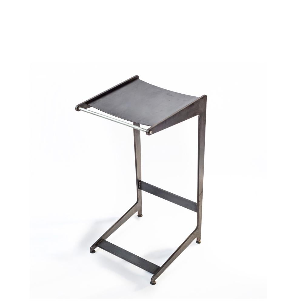 Designed by Basile Built, renowned Design-Fabrication Studio based in San Diego, California, this industrial bar stool is fabricated from hot rolled steel and features a slim front view and seductive profile. Gunmetal-waxed finish will continue to