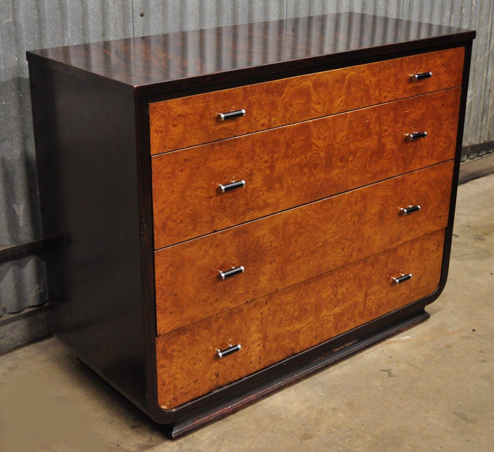 Steel metal Art Deco mahogany painted dresser by Norman Bel Geddes for Simmons. Item features all steel metal construction, wood grain painted finish, in crotch mahogany and burl wood, iconic Art Deco design, metal drawer pulls, original label, and