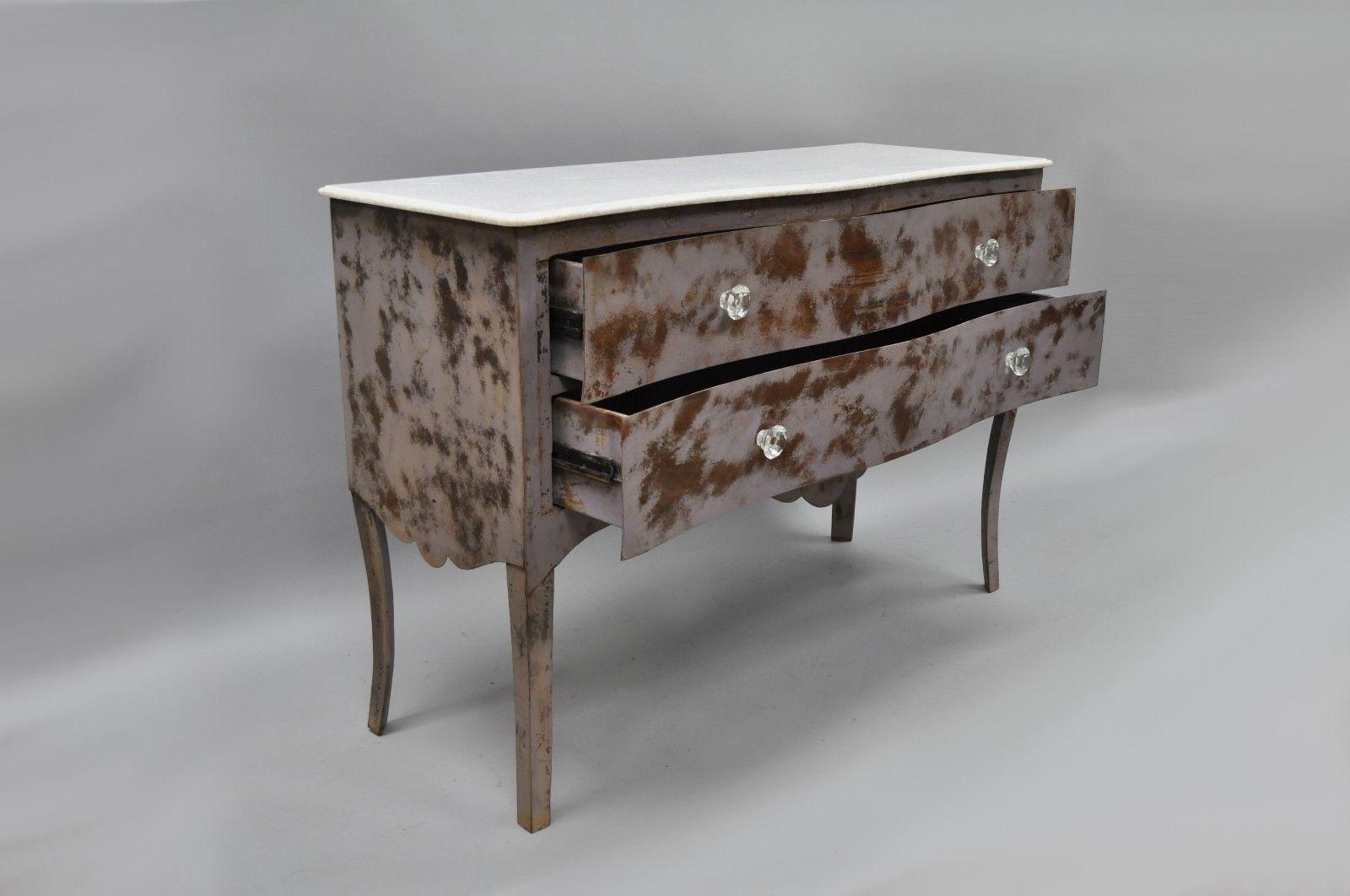 Steel metal French style marble-top bombe commode. Item features distressed purple faux wood grain painted finish, two drawers, glass knobs, unique steel metal frame, interior drawer stoppers, approximately 220 lbs total, unique style and form,