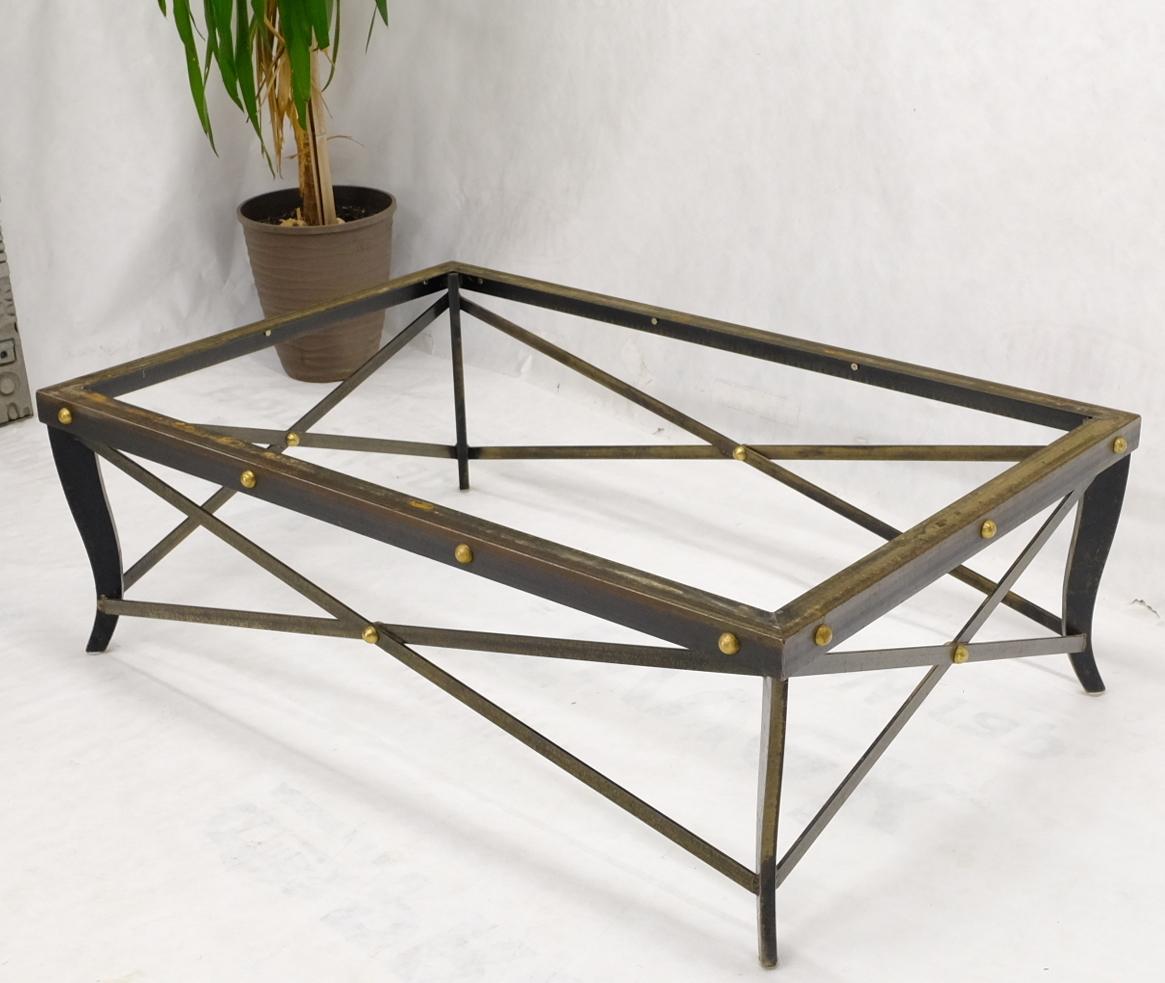 Steel and brass l forged base rectangle coffee table with travertine top.