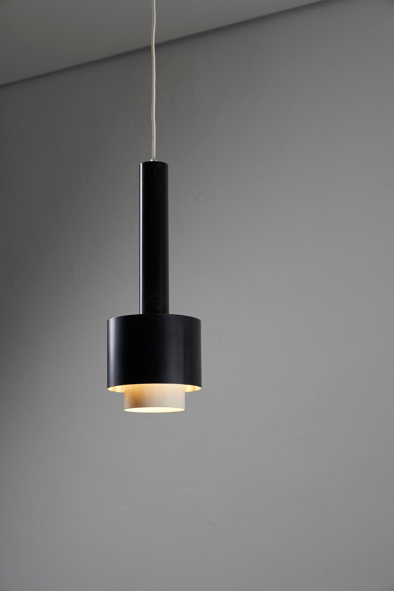 Introducing the Stylish Black Pendant by Philips, a captivating piece hailing from the Netherlands and dating back to the 1950s. This hanging pendant showcases a sleek and sophisticated design that is sure to make a statement in any interior.

The