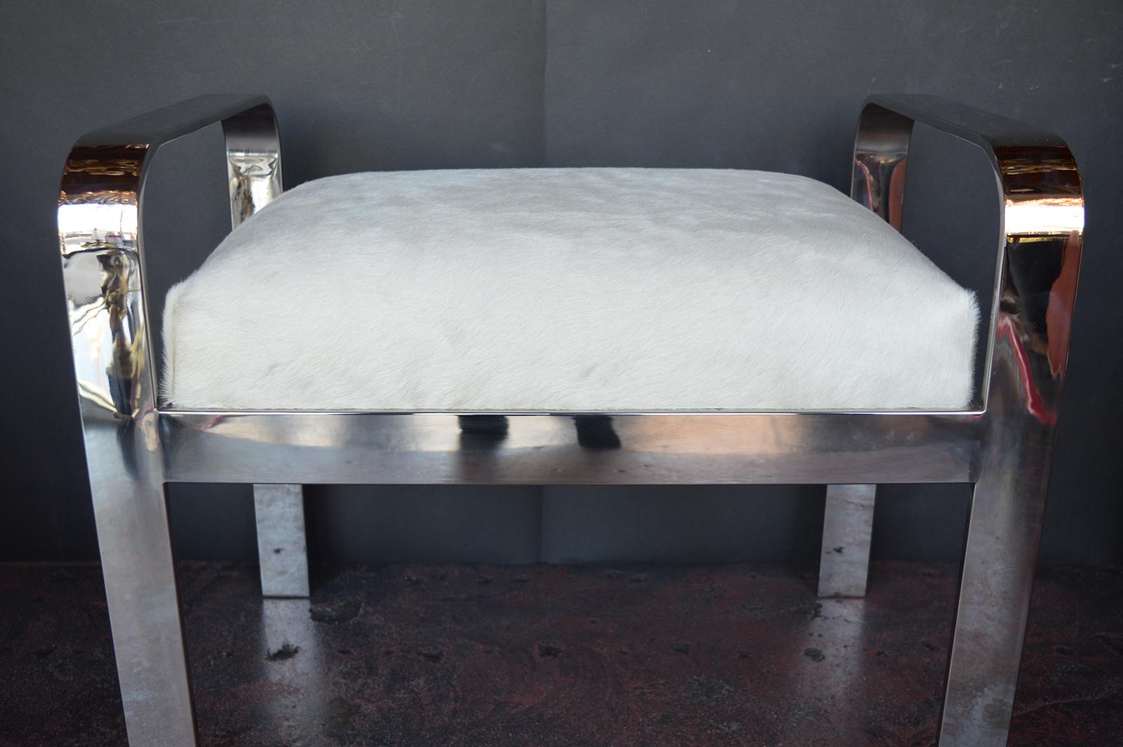 Steel nickel plated stool with white cow hide seat.