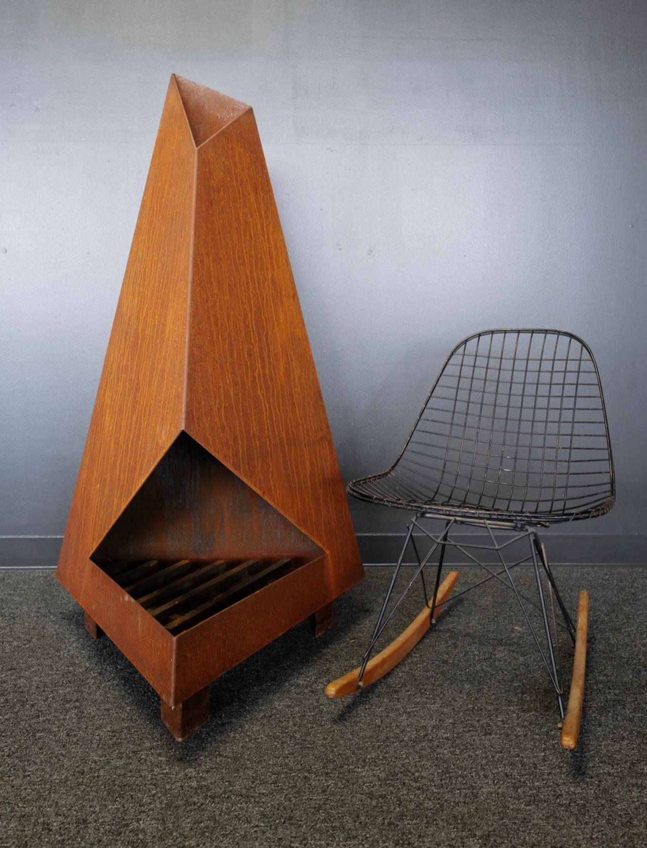 Not your normal chiminea or fireplace.
This high design, raw oxidized steel sculptural piece will make a statement in any outdoor space. Functionally, it is perfect on that cold evening, but also serves as an amazing art display the remainder of the