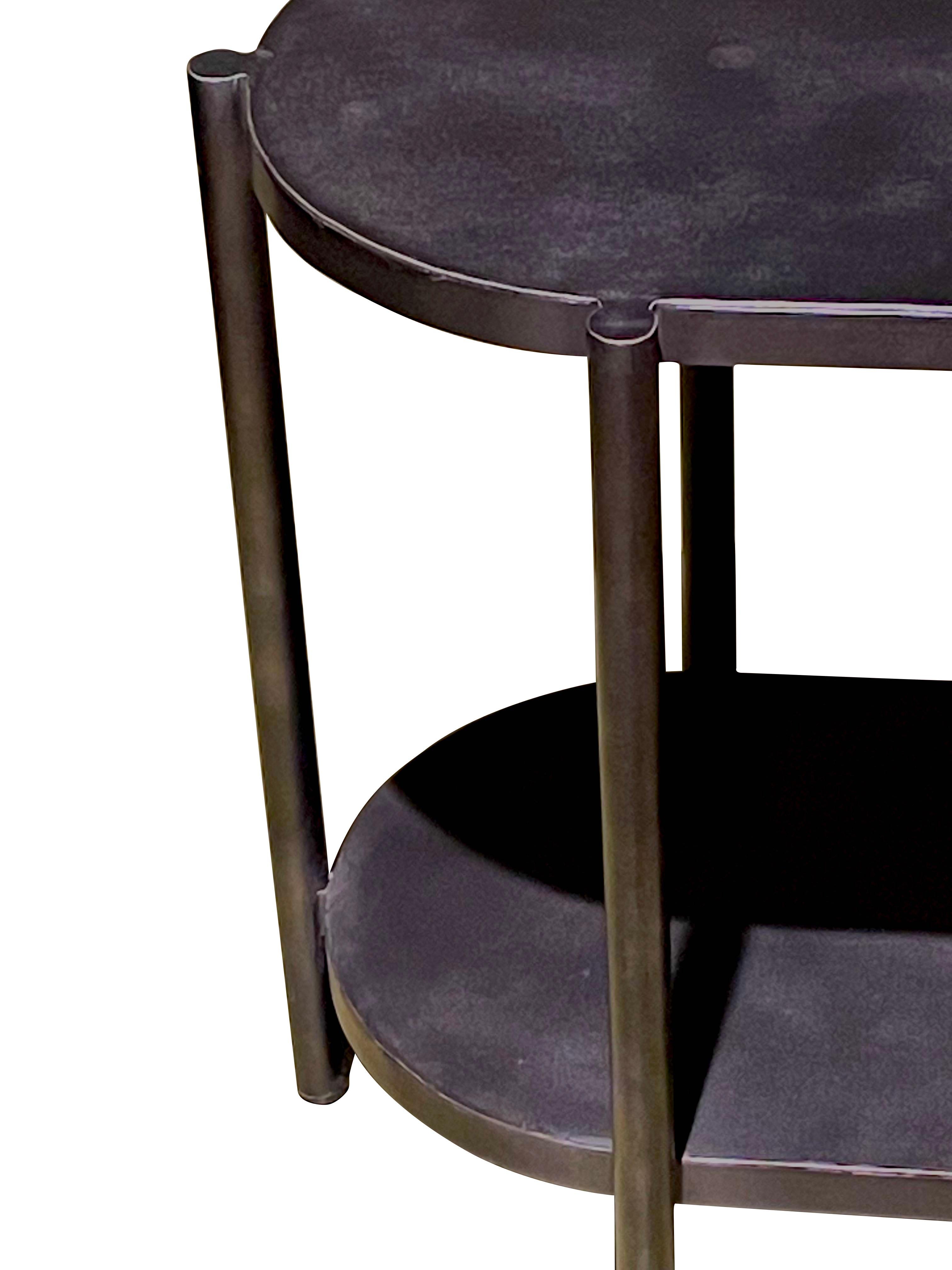 Contemporary Indian oval shaped steel side table.
Six column shaped legs.
Two tiers.

 