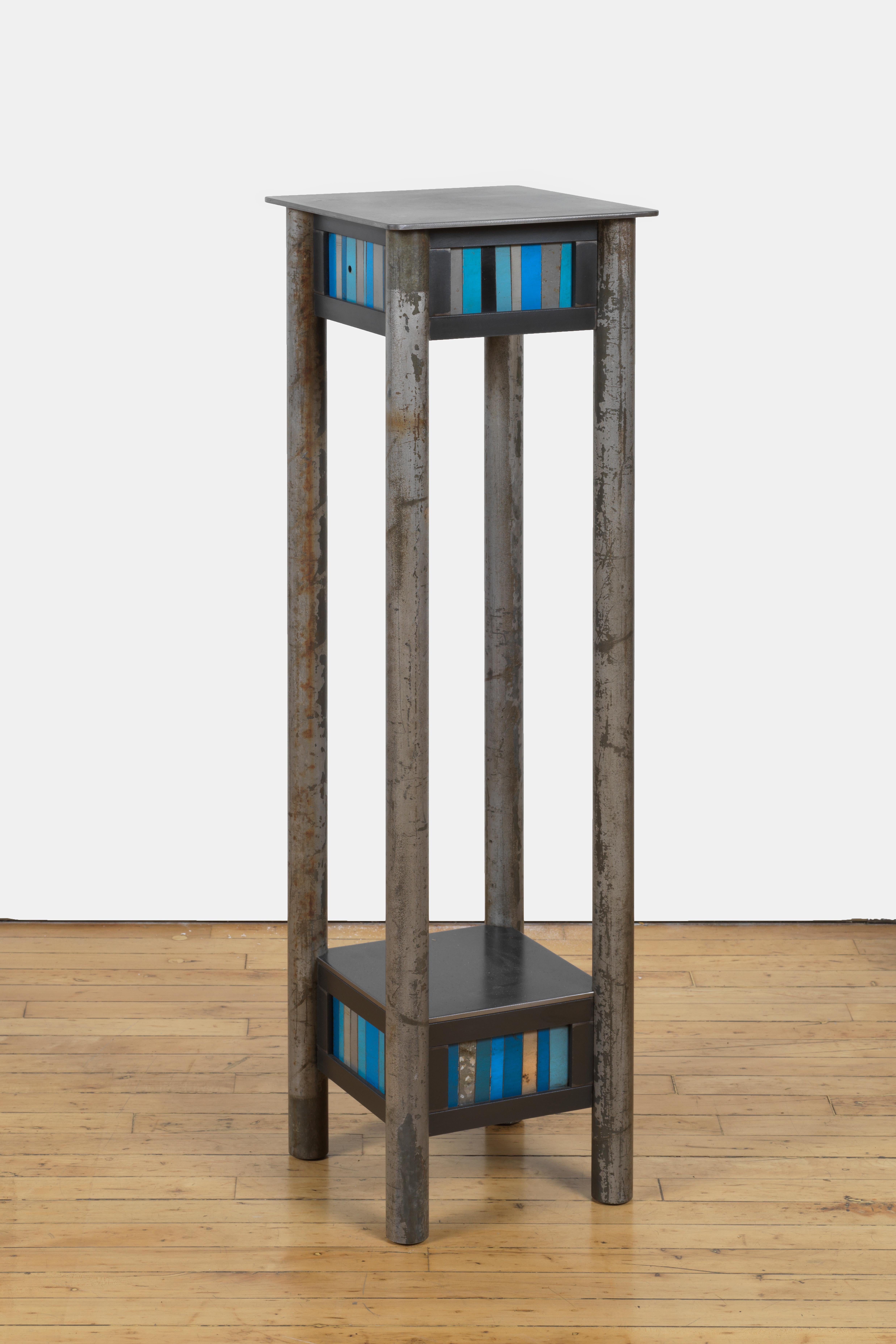 This is a welded steel pedestal with a low shelf and a quilted skirt of found metal strips arranged in a quilt pattern inspired by the quilts of Gee's Bend Alabama. Each piece of furniture is unique and made by Jim Rose. The skirt contains a mix of