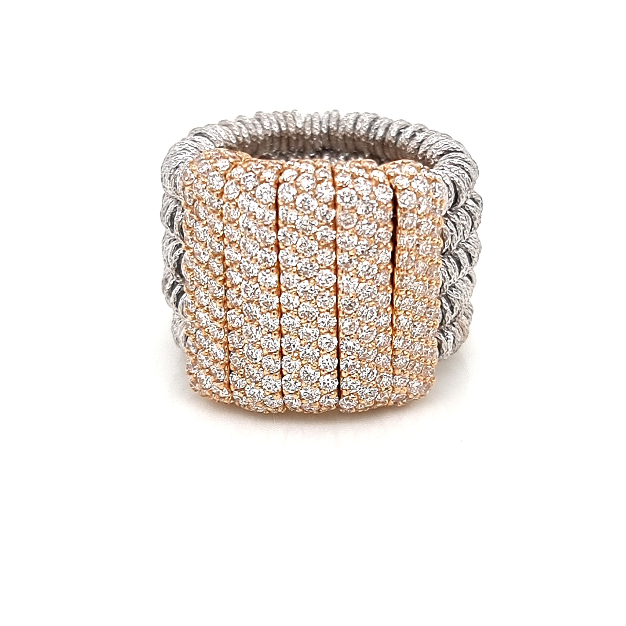 Discover the innovative craftsmanship of Roberto Demeglio with this designer ring, a captivating blend of steel springs and 18K gold elements adorned with 2.74 carats of sparkling white diamonds. This stretchable ring not only showcases the finest