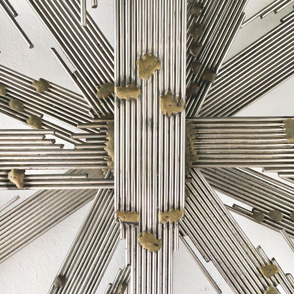 Steel rod lightning starburst wall sculpture with brass soldered decorative detailing 1970s. 

Dynamic in its seven layers this wall sculpture can be manipulated to change the placement of the lightning bolts.  We have photographed it evenly