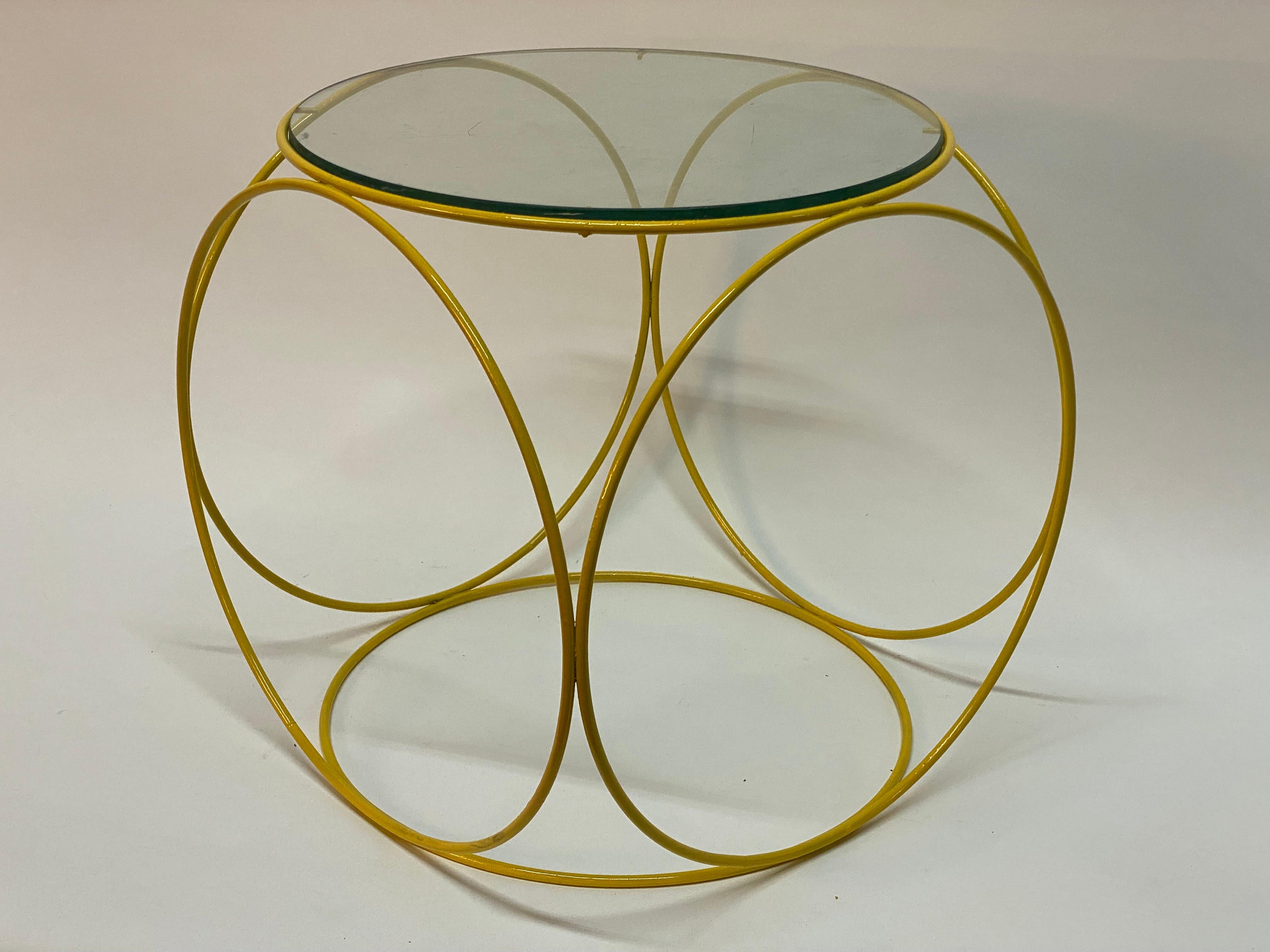 Six sided glass ring table. Circa 1960-70. Solid steel rod construction with flanges to hold glass in place. A great accent side table where the negative space creates fantastic patterns from whichever angle of viewing. Round glass top with green