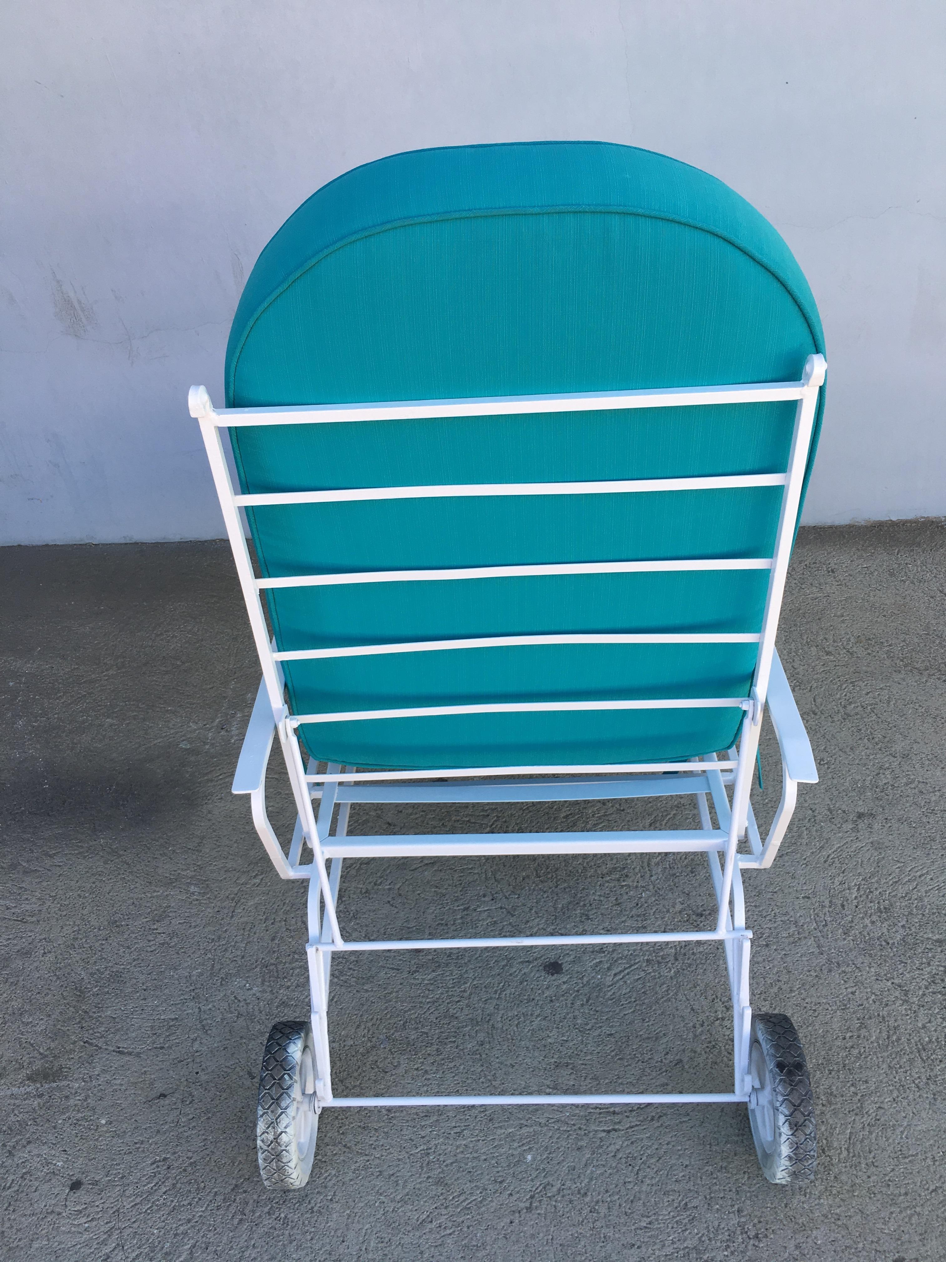 White steel outdoor / patio chaise lounge, produced in 1960 by the Woodard Furniture Company. This comfortable and stylish vintage chaise lounge features a fully adjustable reclining back and back wheels for easy moving. Cushions made to order