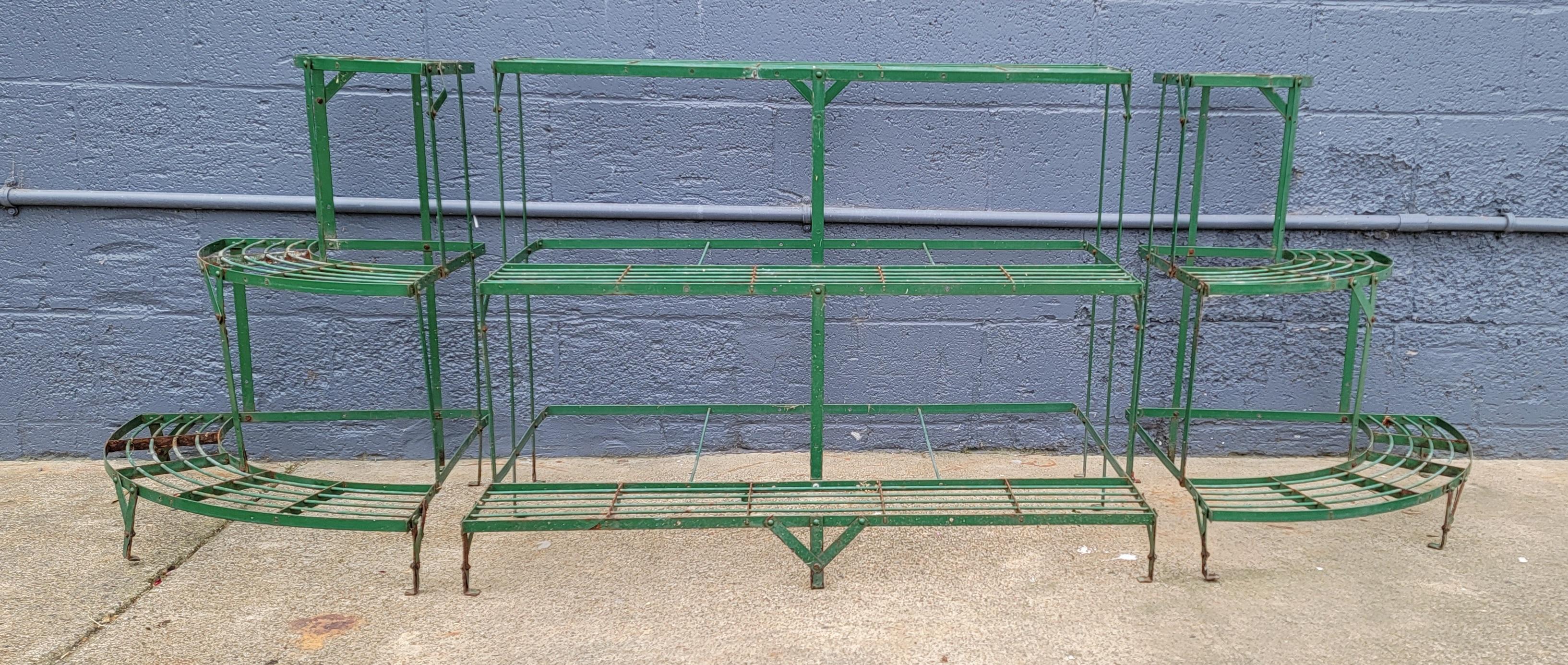 A 3 piece steel flower pot stand / commercial florist display shelf. Nice addition to a garden setting, patio or even indoor use. Center shelf measures 39.25 inches. Original green paint with areas of peeling and loss and light oxidation to steel.