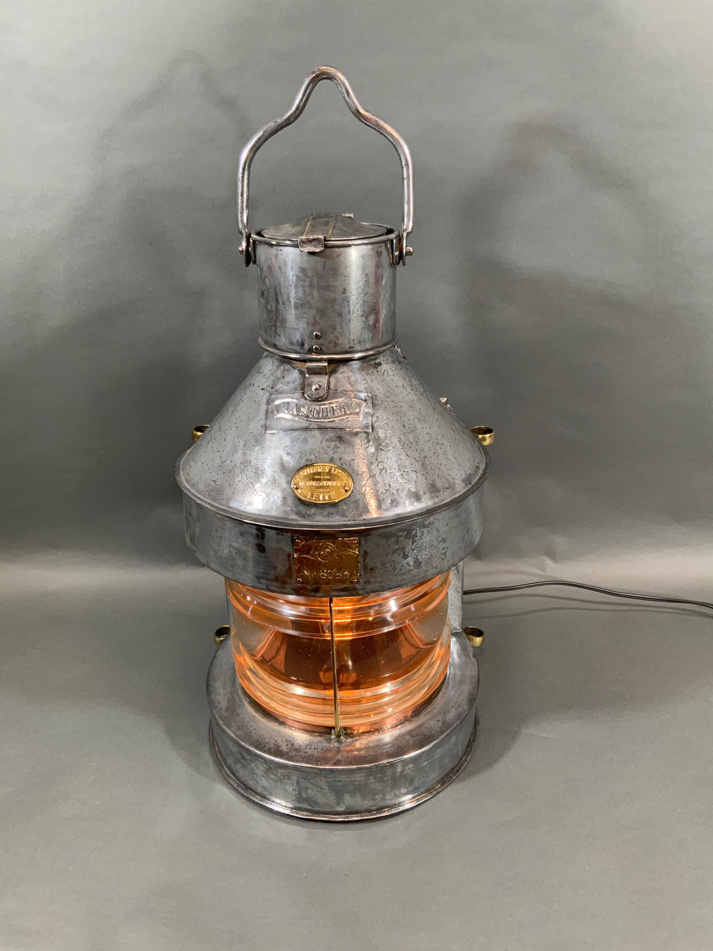 Ship's lantern by Scottish maker M.P. Calloway Limited Manufacturers of Leith. The steel case has been meticulously polished and lacquered. Fresnel glass lens with brass bezel. Heavy hoisting handle. Sliding rear panel. Wired with socket and wire