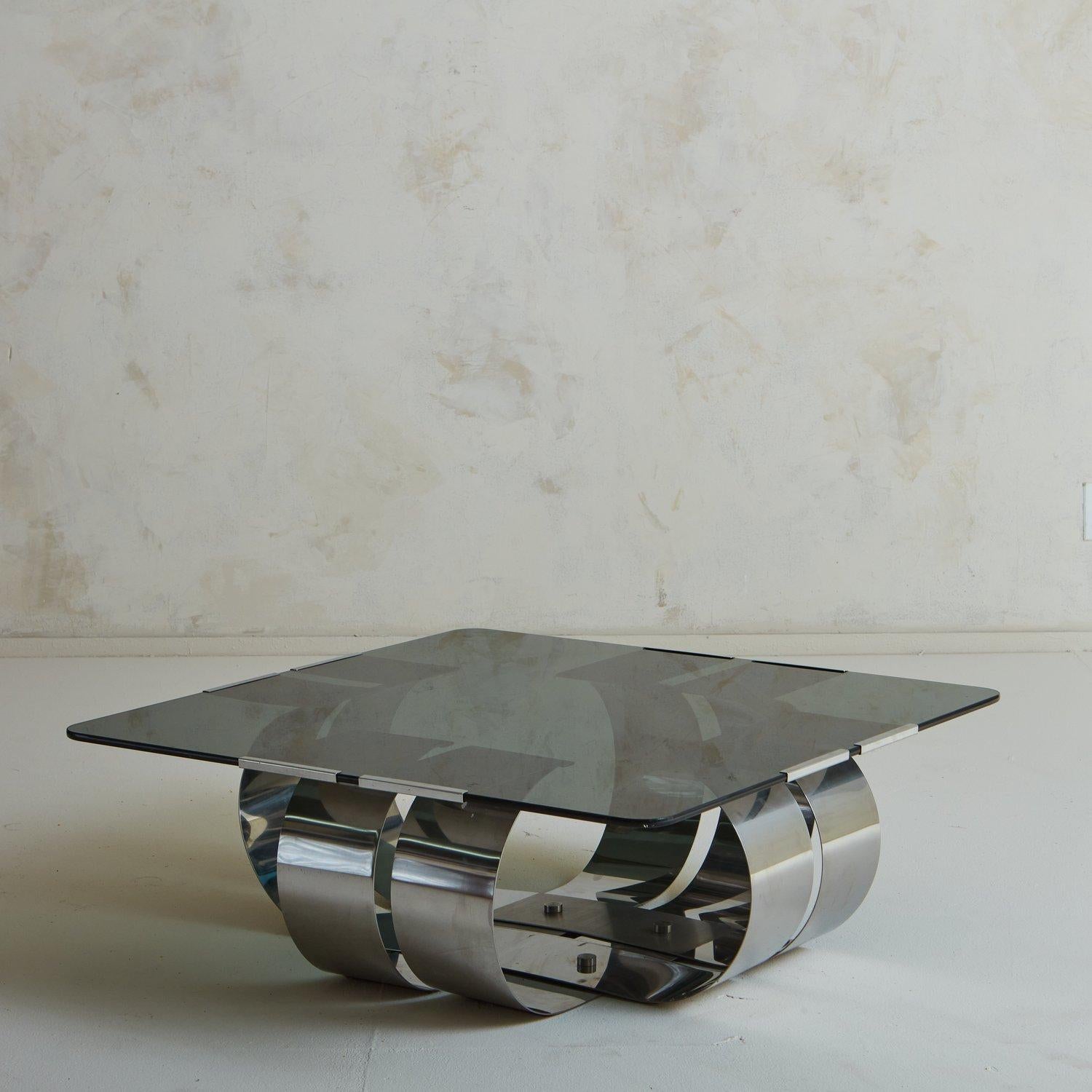 A captivating French coffee table designed by François Monnet in the 1970s. This table has a sculptural curved steel base and an inset square smoked glass tabletop with rounded edges. Unsigned. Sourced in France, 1970s.

