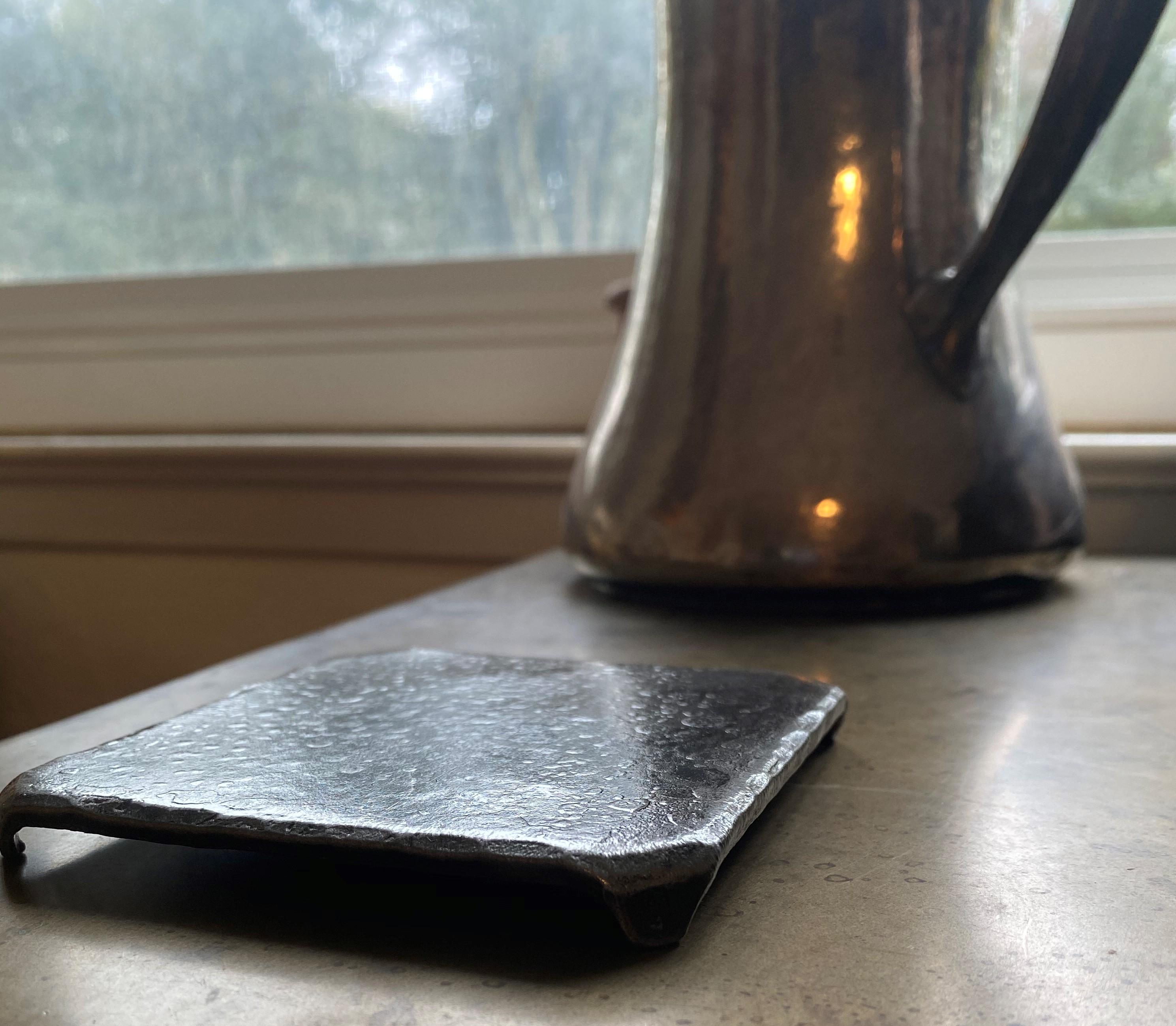 These custom handcrafted, steel square coasters with hammered, beveled edges are a beautiful edition to your coffee table. They are carefully wire brushed and sanded to accentuate the forged details of design. A glossy clear coat enhances the