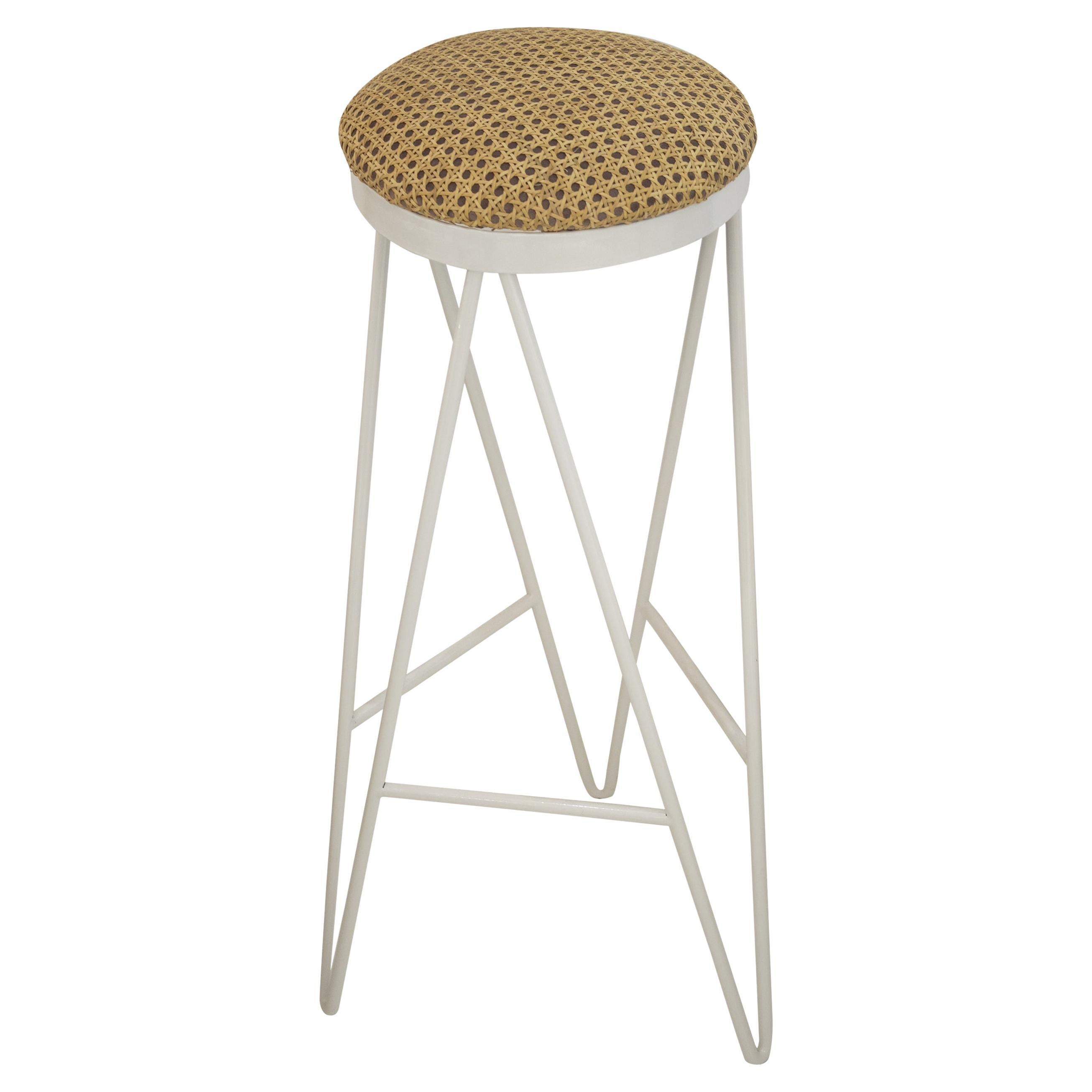 Contemporary bar stool designed by IKB191 Studio in a limited edition.
It consists of a white lacquered steel structure, and a foam seat, upholstered in wicker.
Made in Spain, 2022.