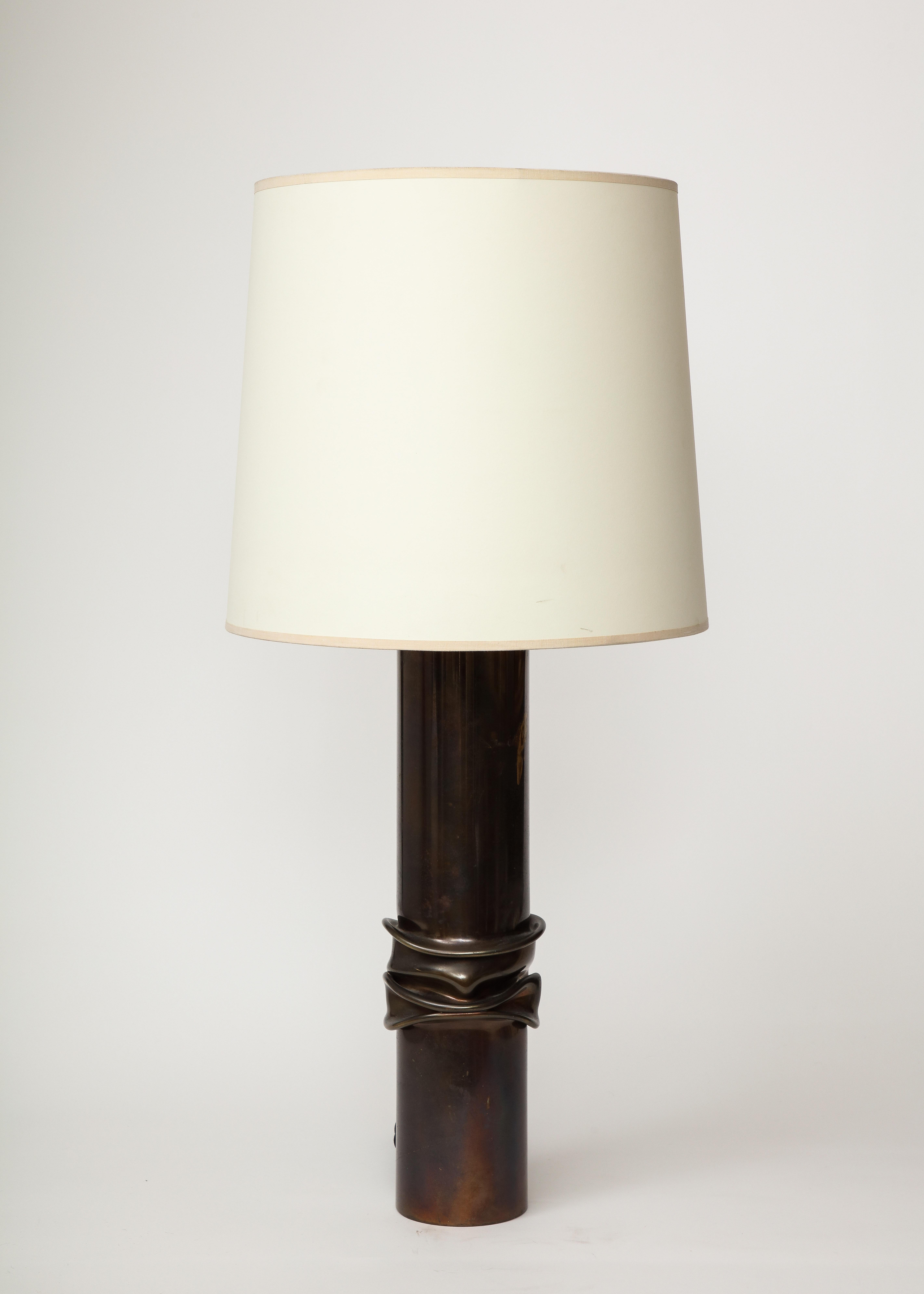 Tall, sleek design. It looks as if the center lamp went through a hydraulic press or melting process. Industrial yet refined.

This table lamp was recently rewired with a black twisted silk cord, bronze hardware, a dimmer at the neck, and an