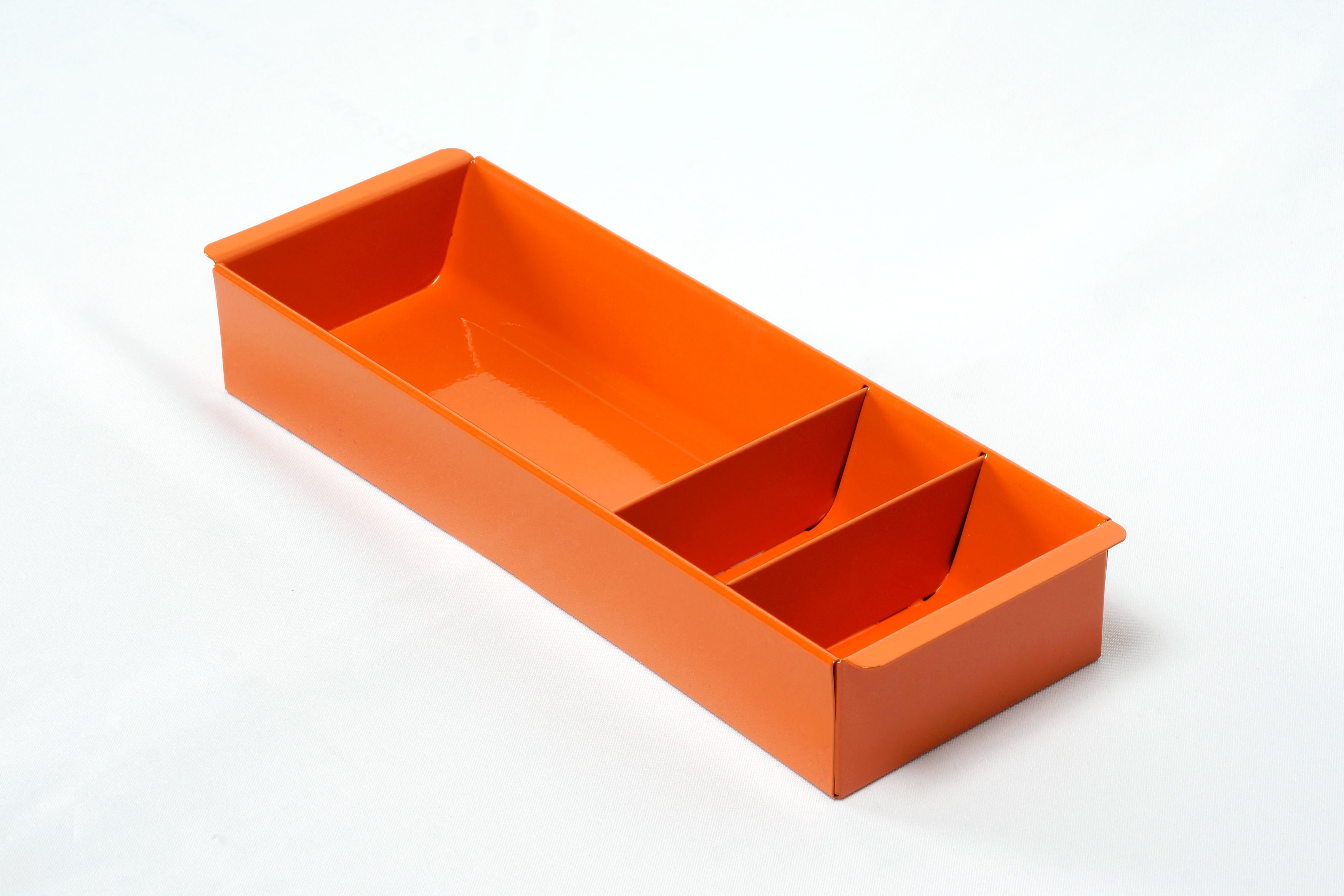 Once the insert to a classic tanker desk's utility drawer, we repurposed this neat industrial piece for use as a desktop organizer. Steel has been newly powder-coated in a pop of high gloss Tangerine (OG05). Features three slots, ideal for storing