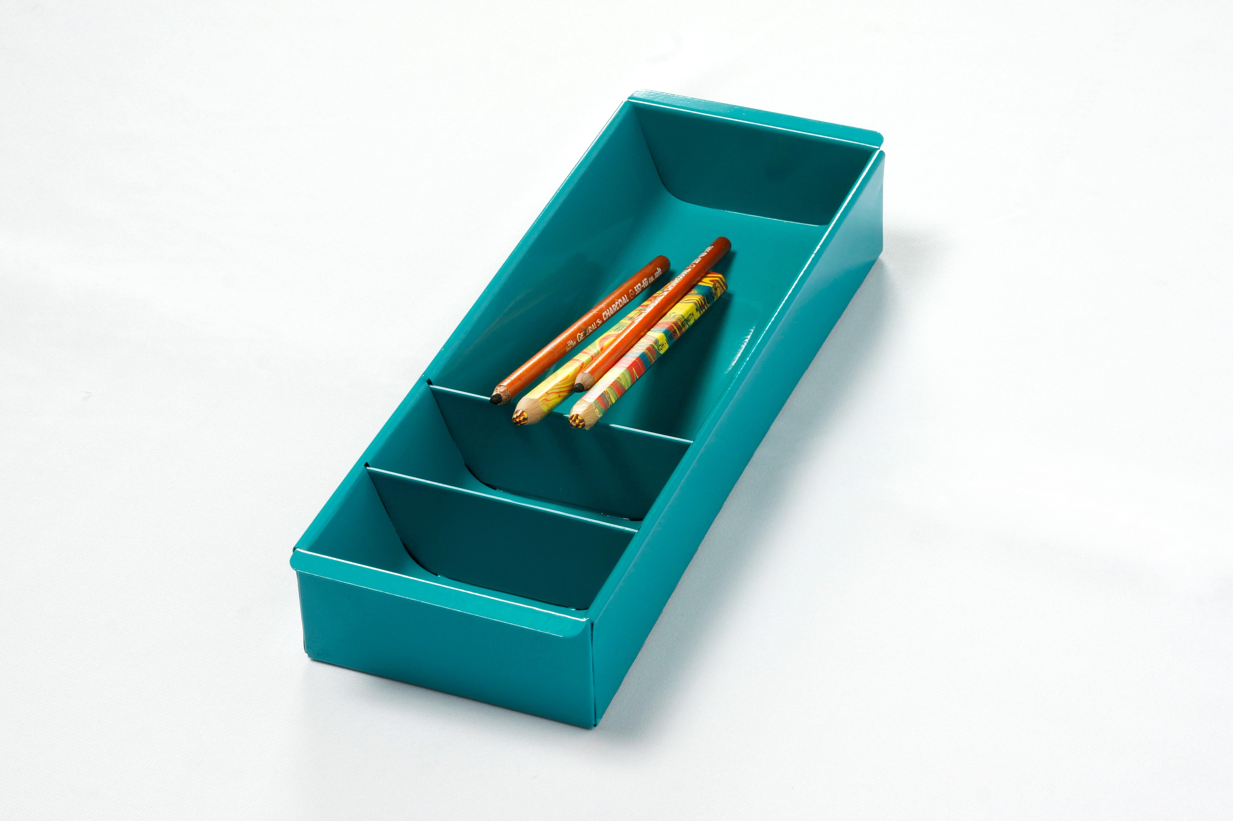 Once the insert to a Classic tanker desk's utility drawer, we repurposed this neat Industrial piece for use as a desktop organizer. Steel has been newly powder-coated in a pop of Turquoise (RAL5018). Features three slots, ideal for storing coins,