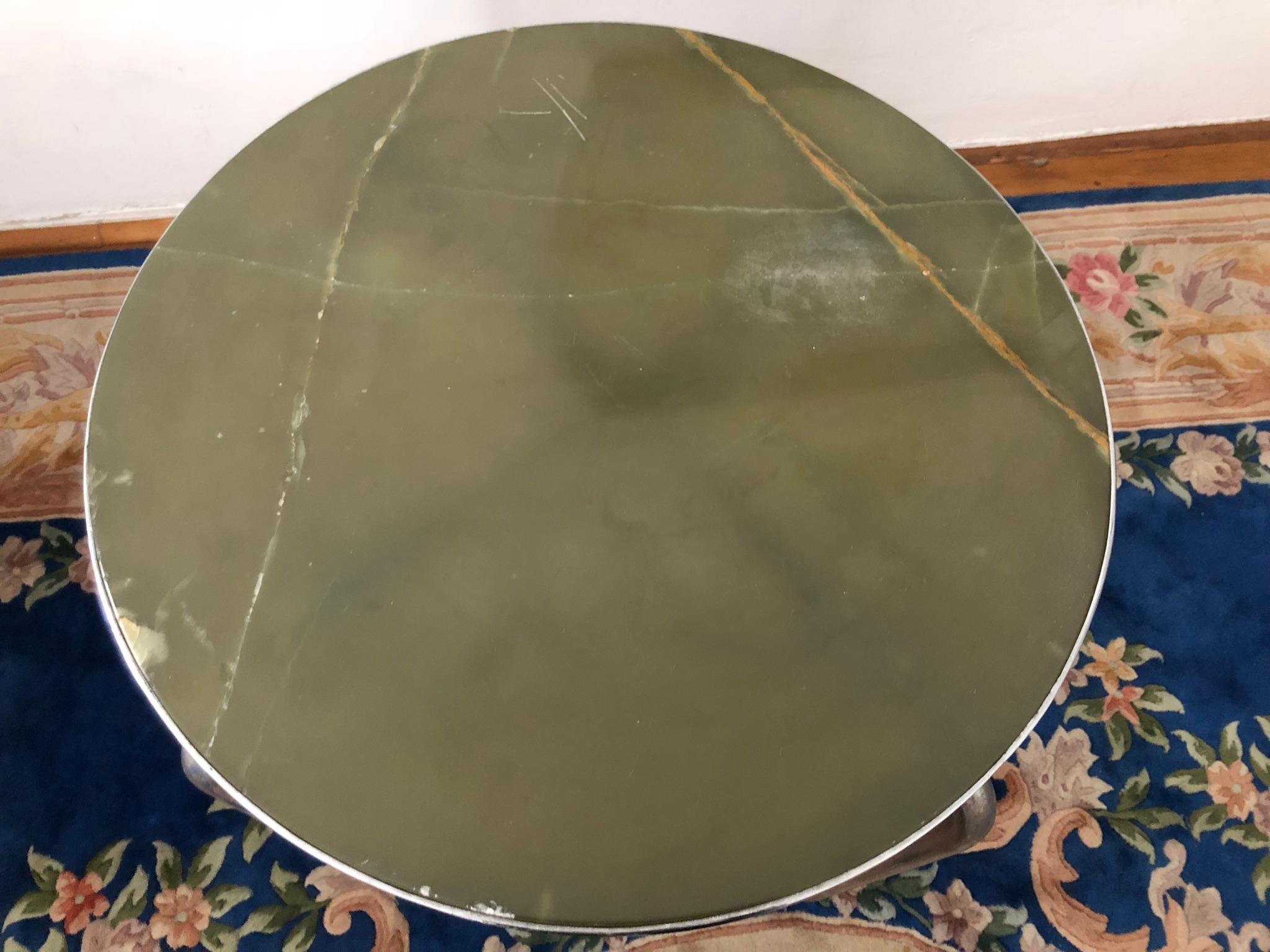 This steel tube side table or center table has an exquisite solid onyx plate. 
We searched far and wide to be able to attribute this piece, it is probably connected to Bauhaus, to Marcel Breuer, but we cannot offer any guarantees, unfortunately.