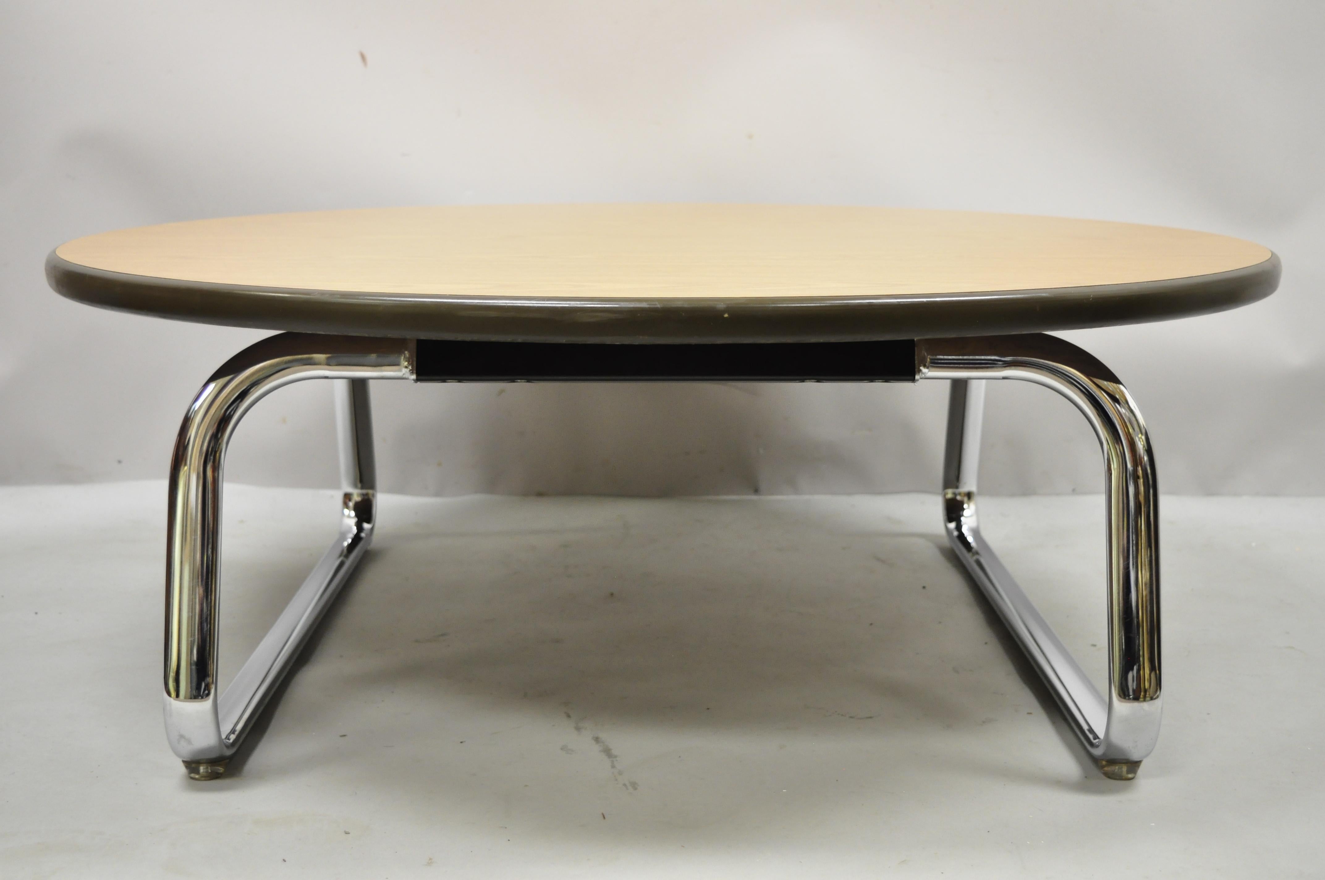 Steelcase chrome base round Formica top Mid-Century Modern office coffee table. Item features round formica top in faux wood grain, original label, very nice vintage item, clean modernist lines, great style and form, Circa late 20th century.