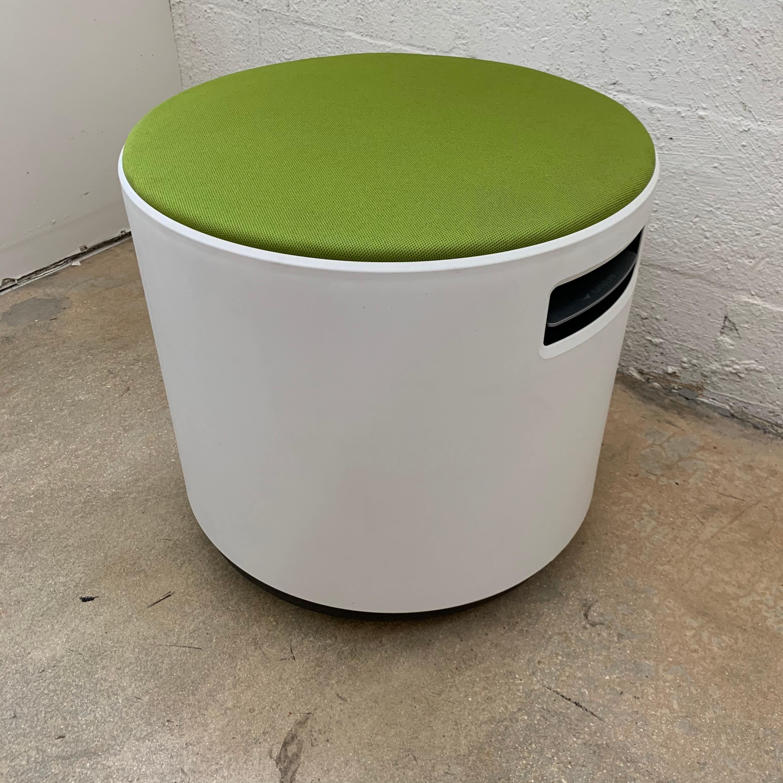 Rotating and tilting and adjustable height stool rendered in white polypropylene plastic with green upholstery by Steelcase.