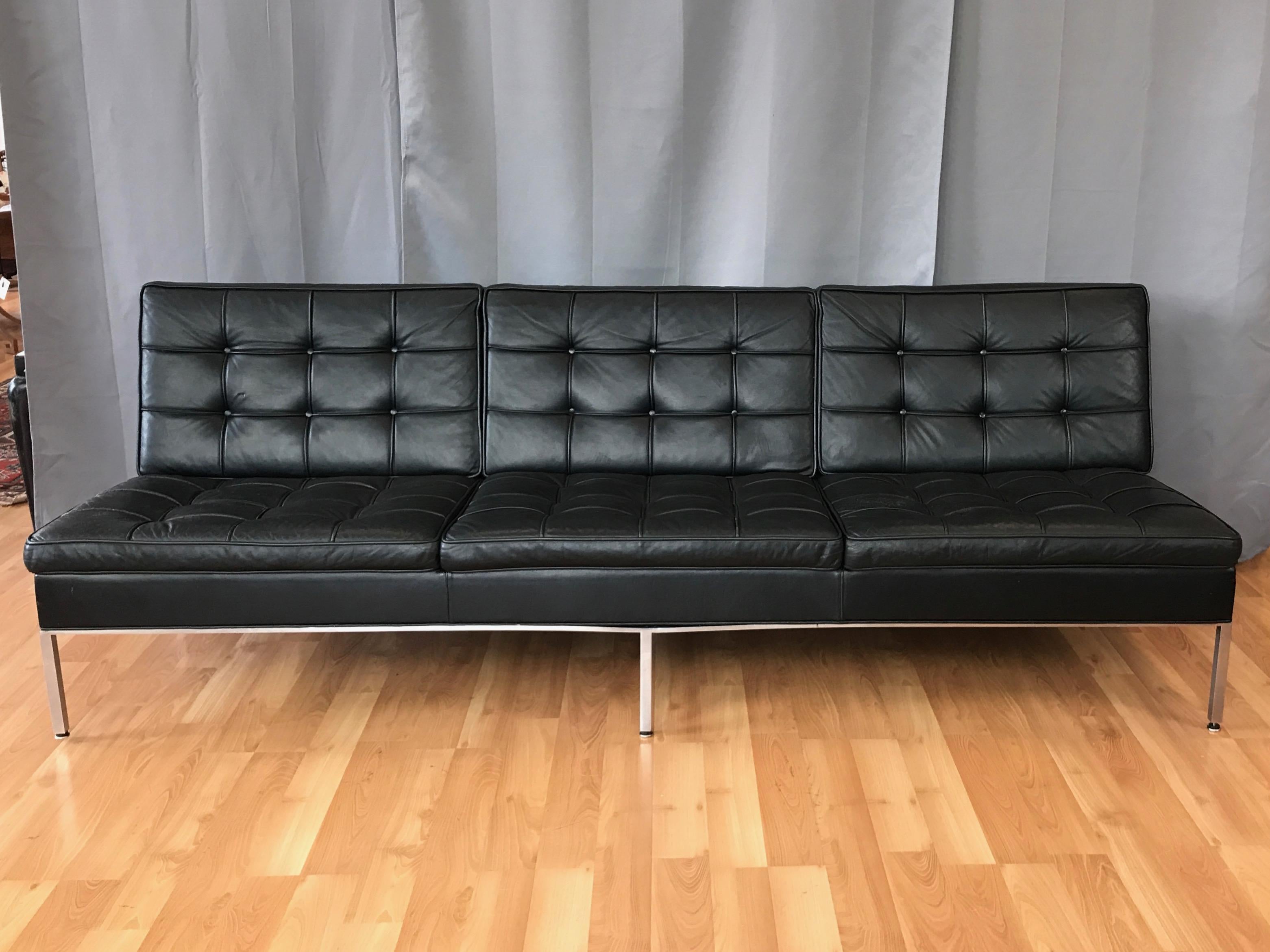 An extra-long, exceptionally handsome, and quite uncommon 1960s tufted black leather sofa by Steelcase.

Minimalist Mid-Century Modern design with carefully considered angles subtly aligned for maximum comfort, giving this impressive vintage sofa