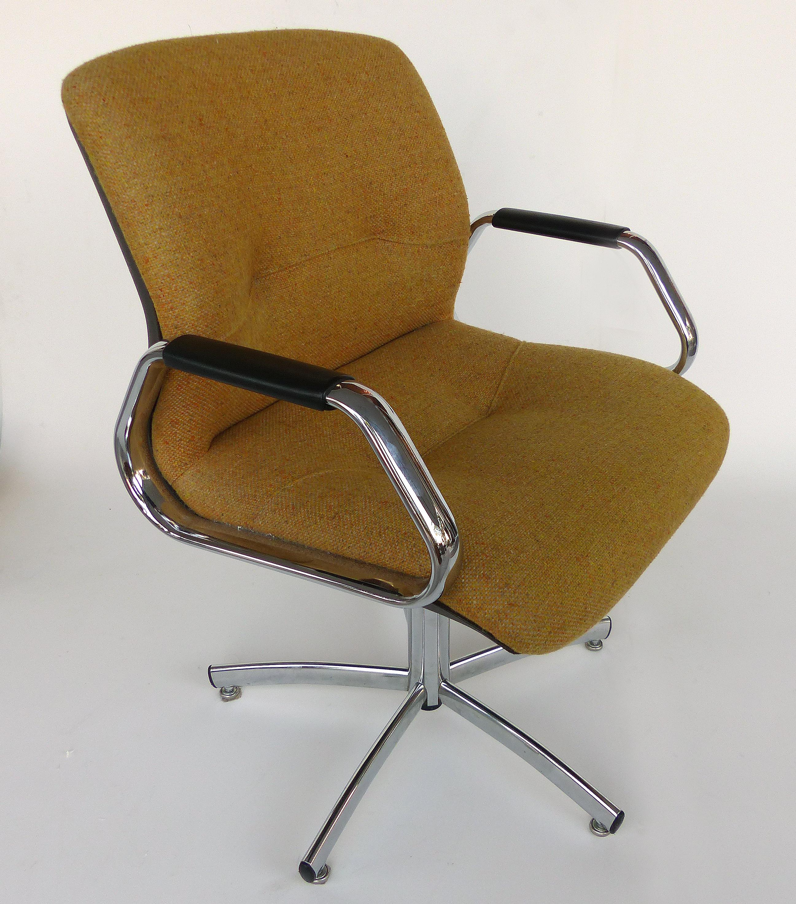 Offered for sale is a modern adjustable swivel/tilting armchair manufactured by the Steelcase Furniture Company of Grand Rapids, Michigan. Height is adjustable by loosening the knob beneath the seat and then rotating the chair to raise or lower. The