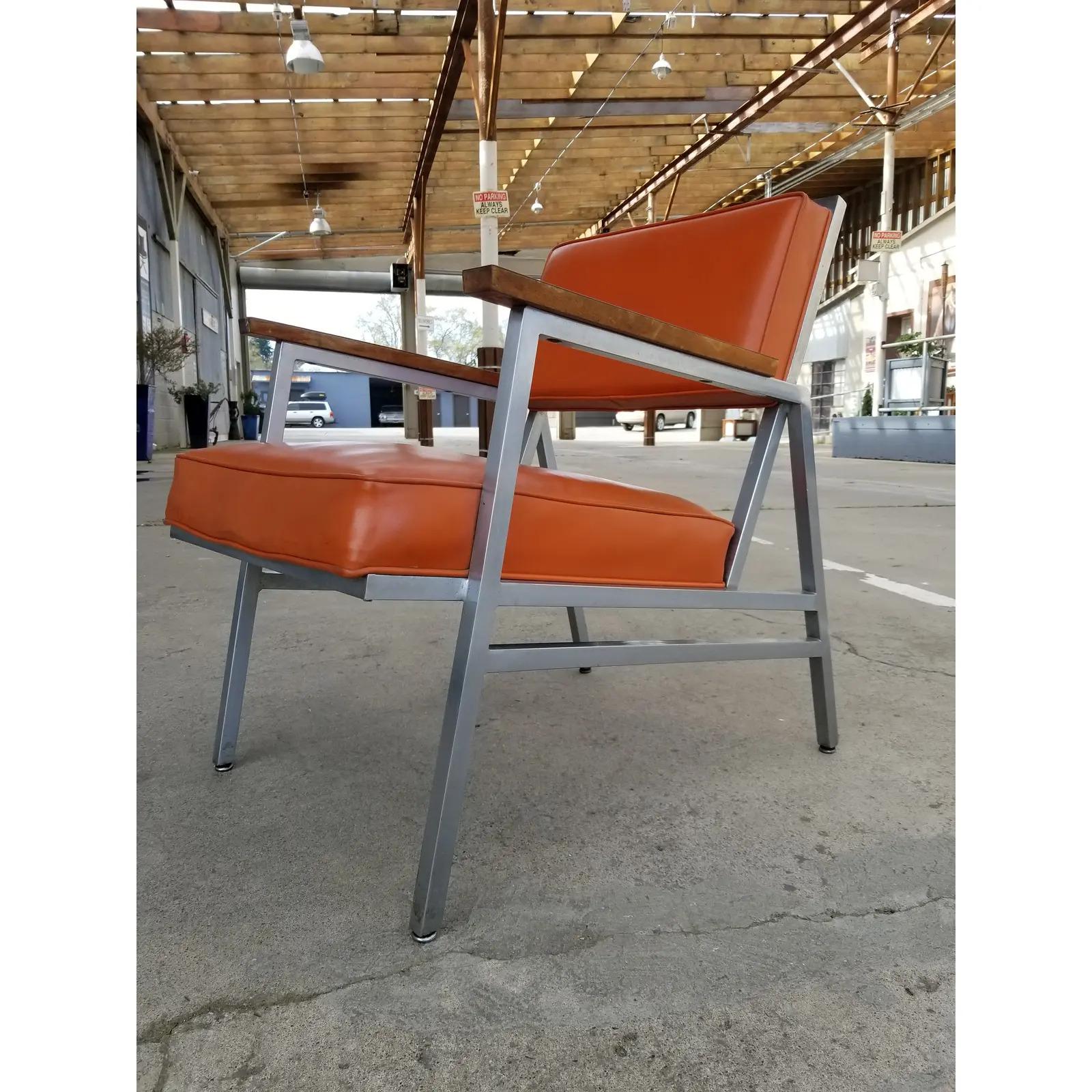 A Mid-Century Modern armchair originally intended for commercial use by Steelcase. Welded steel frame creates a very sturdy and durable chair. Fantastic, original orange vinyl upholstery in exceptionally good condition. A very nice example of