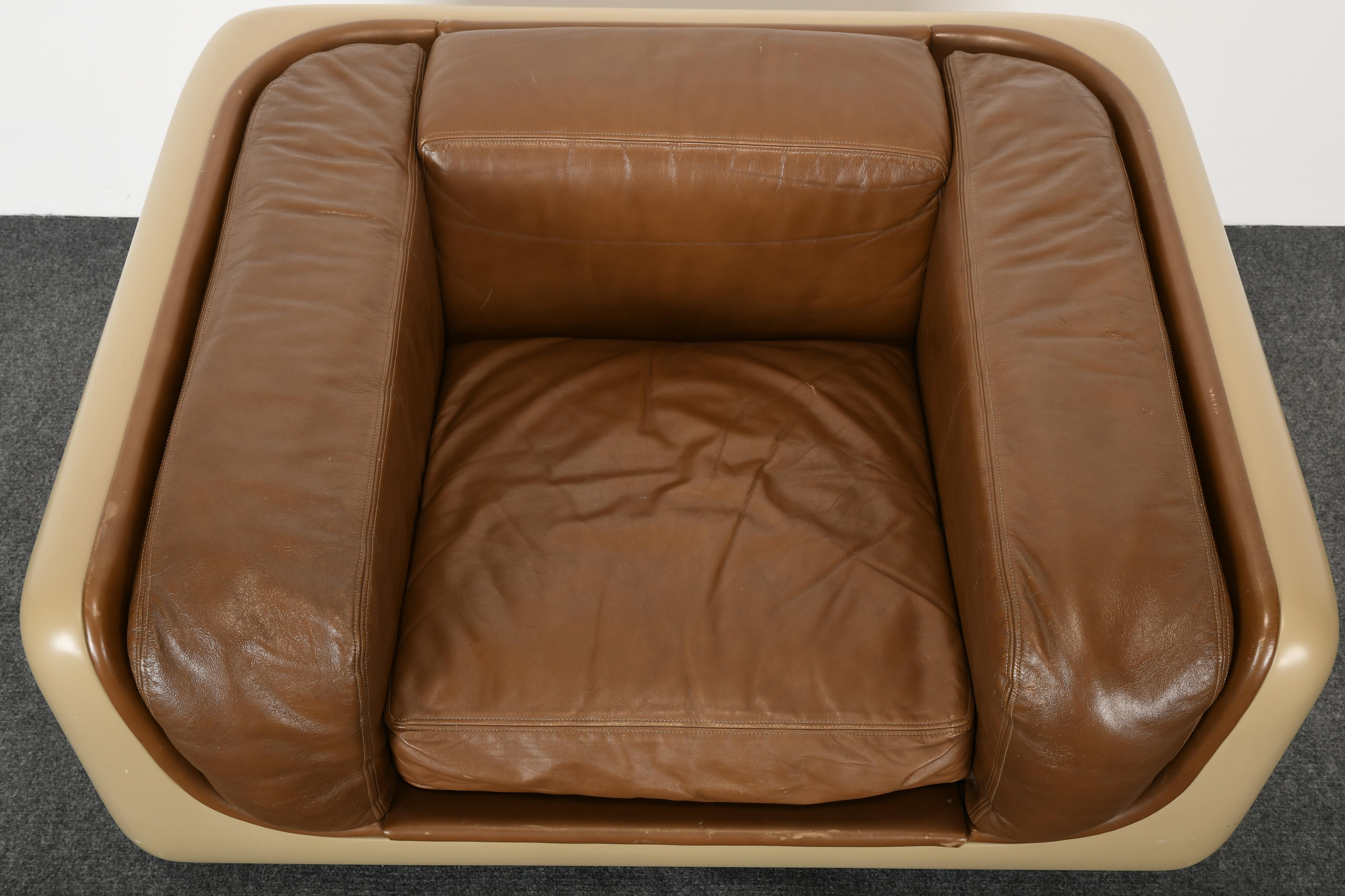 A fiberglass and floating Lucite lounge chair designed by William Andrus, 1970s. Retains original leather seat cushion. Fiberglass has age appropriate wear, one minor hole to leather seat and one pinhole in fiberglass. Labeled Steelcase underside of