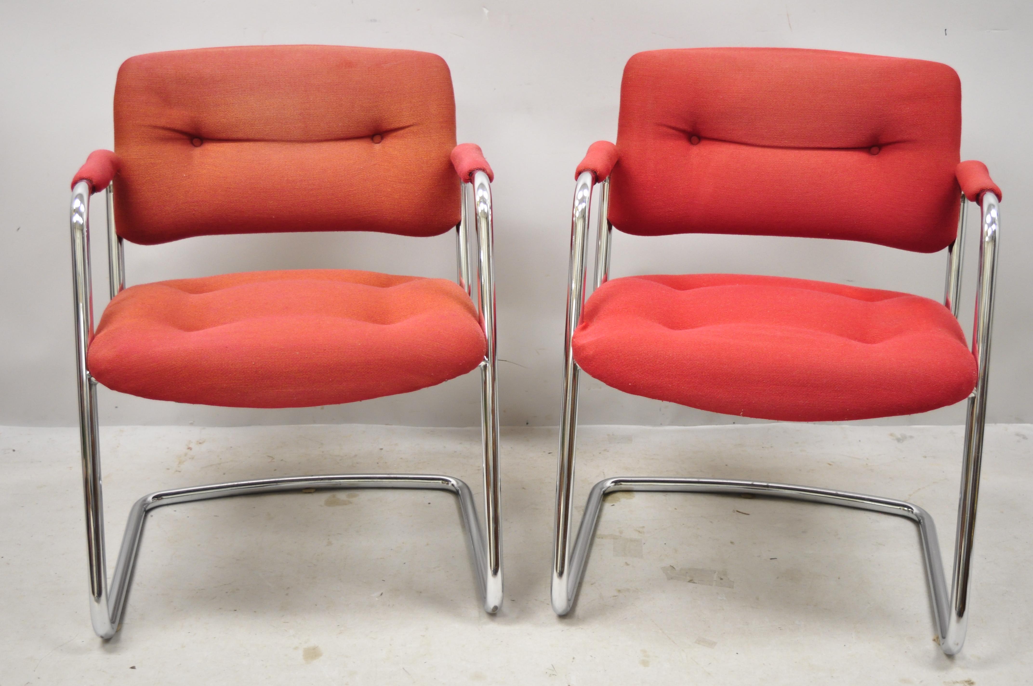 Steelcase Mid-Century Modern tubular chrome red upholstered arm lounge chairs (B). Item features sleek tubular chrome frames, red tufted upholstery, upholstered armrests, original label, very nice vintage item, clean modernist lines, quality