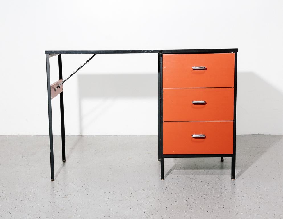Steel frame desk by George Nelson for Herman Miller, 1950s. Black painted steel frame, white laminate top, and red painted drawers. Signed on inner drawer.