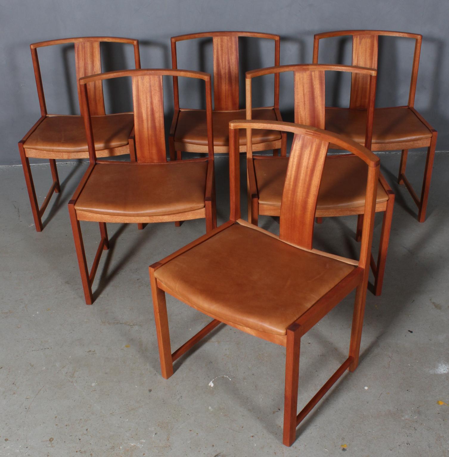 Steen Eiler Rasmussen set of six dining chairs in mahogany.

Seat new upholstered with vintage tan aniline leather.