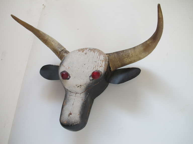 Steer head of pieced wood with steer horns metal ears and reflector eyes
Mounting bracket included for wall attachment at an angle.