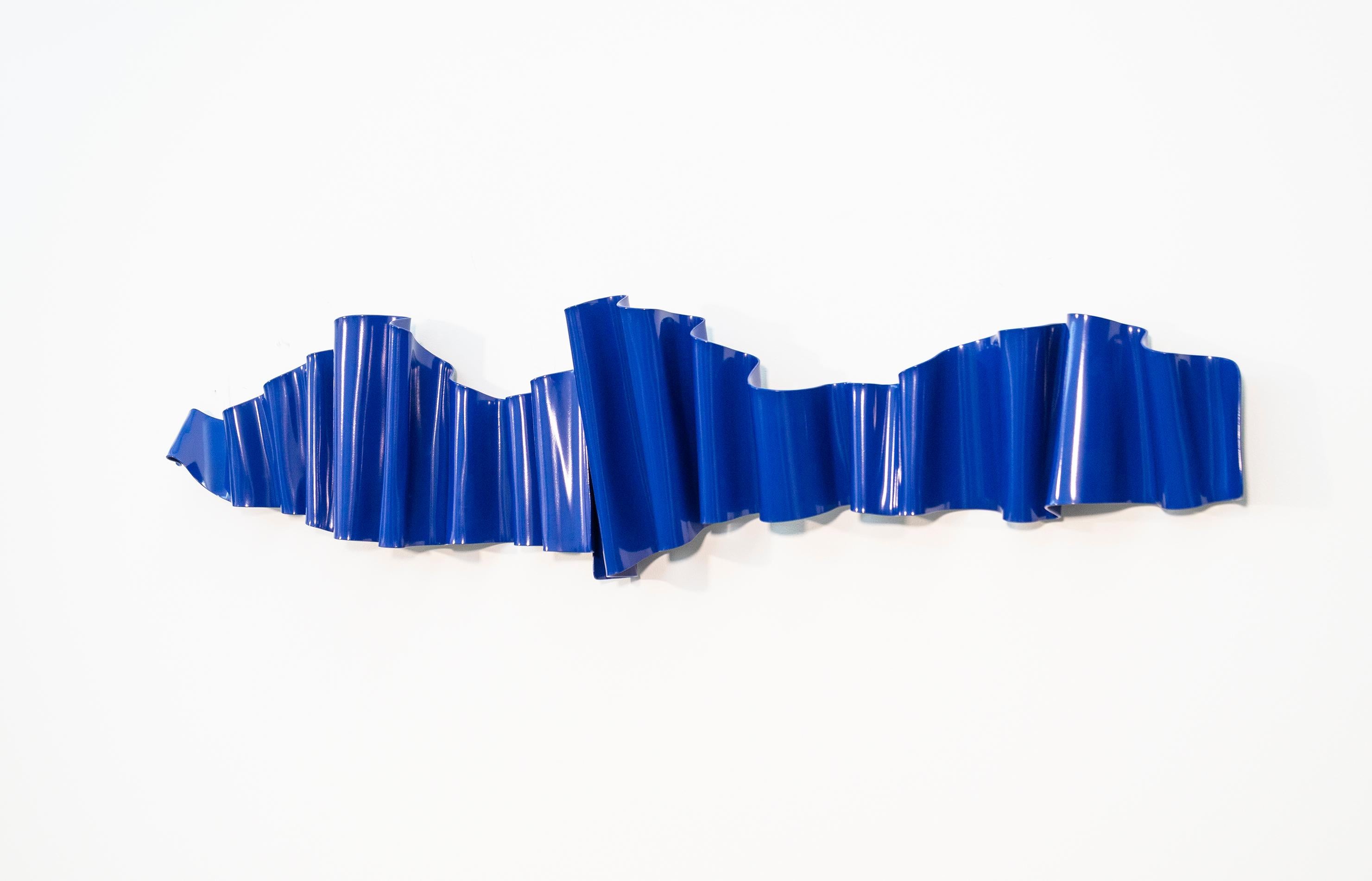 A contemporary wall sculpture hand forged from steel acquires an expressive undulating form in the hands of artist Stefan Duerst. This horizontal piece is actually two pieces that overlap one another. (a diptych) Powder coated in a rich royal blue,