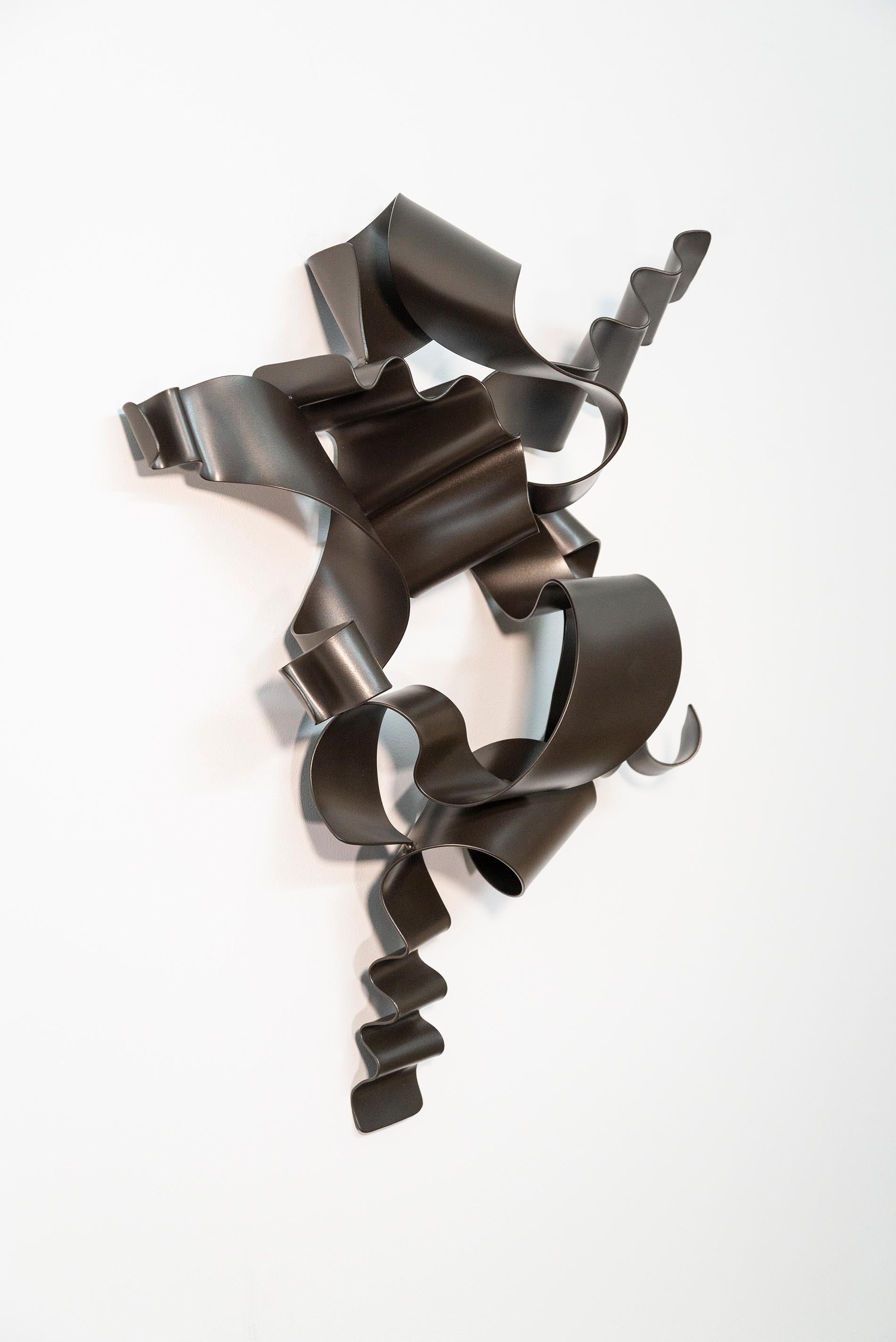 Expressive and lyrical, Stefan Duerst’s dynamic wall sculptures are visually arresting contemporary pieces. Hand forged from ribbons of steel and coated in black, several ribbons undulate, curl and ‘flow’ around one another. The German born artist