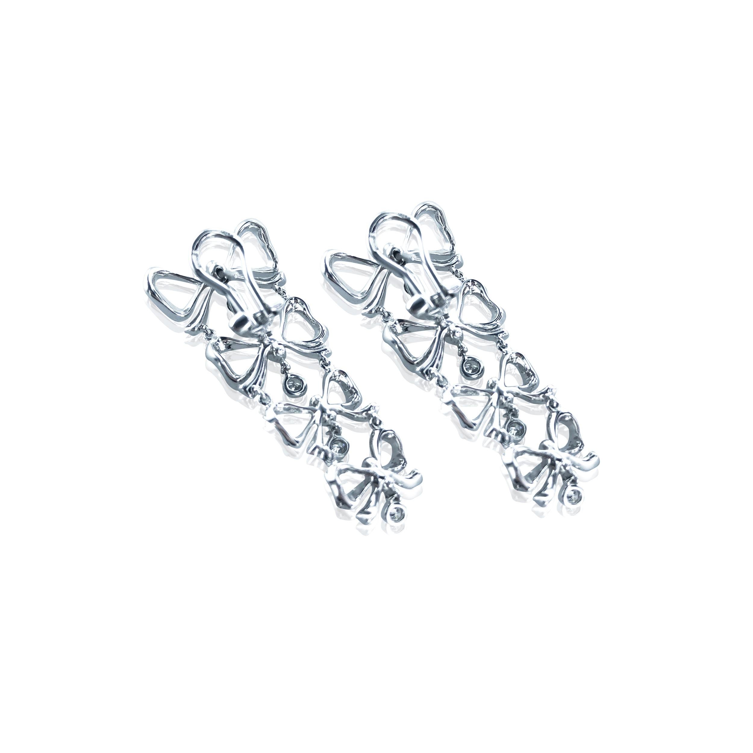 These Stefan Hafner 1.52 Carat Diamond Birthday Bow dangling earrings, consist of 4 bows decreasing in size with a dangling round diamond at the bottom of each. 
Set in 18kt white Gold with latch back closures, they are fashionable and modern