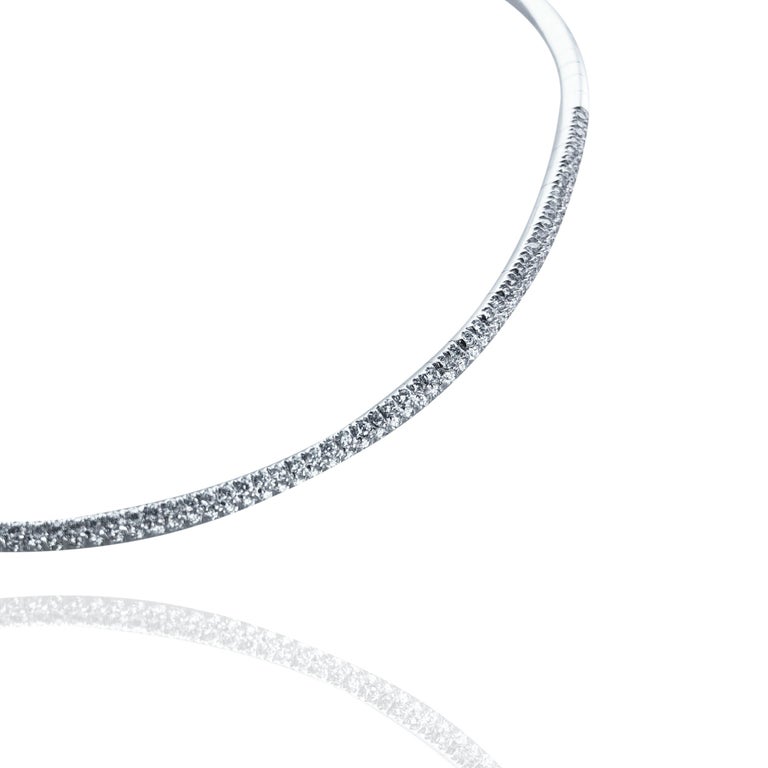 This half pave 1.85 Carats Diamond Half Pave Stefan Hafner Choker, is set in 18kt white Gold. 
With a bracelet catch clasp and Gold chain to close the necklace, it can dress a neck of 10.5 cm and can be tightened up to 3 cm. 

Using the purest