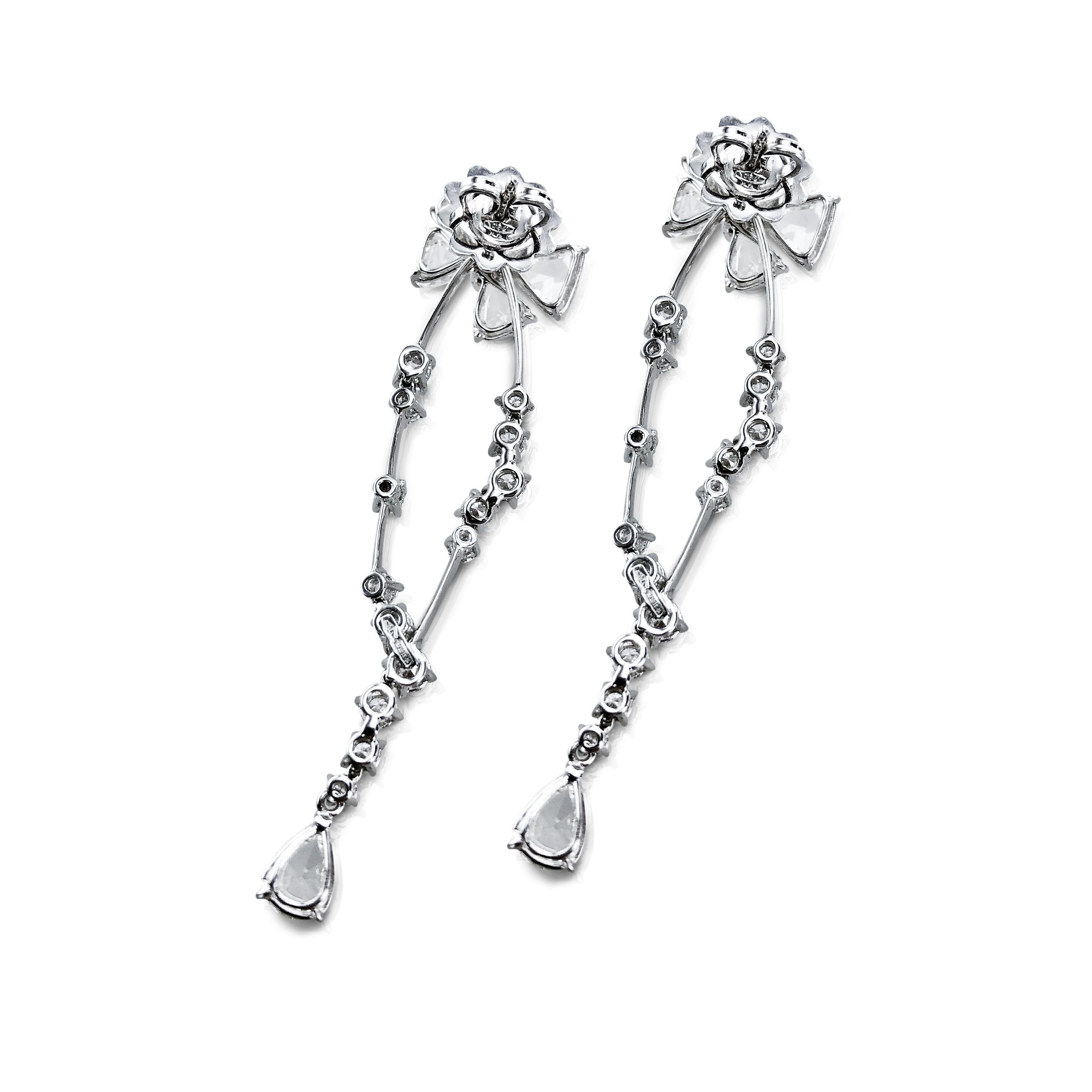These 7.42 Carat diamond Rose Cut dangling earrings are beautifully set in 18kt white Gold.  

The unique craftmanship dangles Rose Cut diamond bows (1.5cm width by 1.1cm length each bow), that are securely held in place on the ears with butterfly