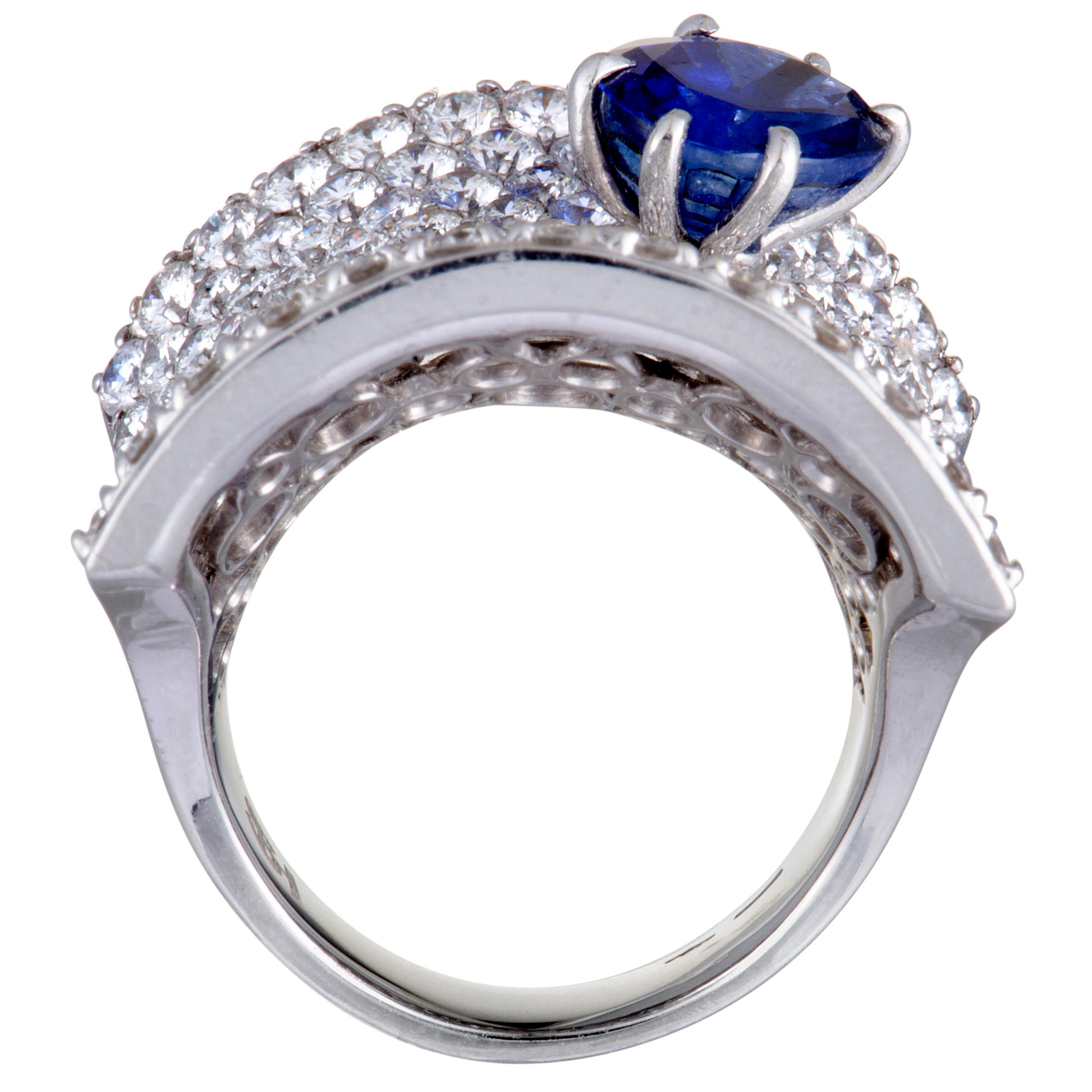 A sense of utmost extravagance and prestige is achieved in this fabulous jewelry piece through combining the ever-resplendent diamonds with the regal allure of sapphire and setting them against the luxurious sheen of 18K white gold. The ring is